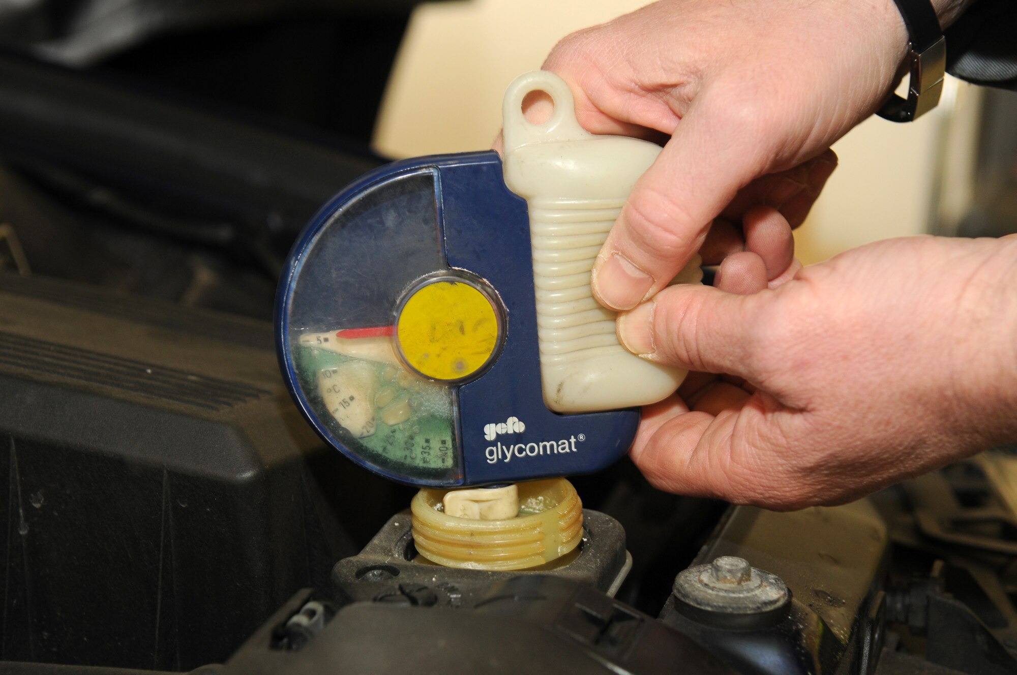 SPANGDAHLEM AIR BASE, Germany – Herbert Fuss, ADAC representative, test the ratio of water and antifreeze in a radiator during a winter check Oct. 23. ADAC, a German auto club similar to the American Automobile Association, visited the base and partnered with the 52nd Fighter Wing Safety Office to perform free inspections on privately owned vehicles to identify potential hazards before winter driving conditions arrive. (U.S. Air Force photo/Staff Sgt. Benjamin Wilson)