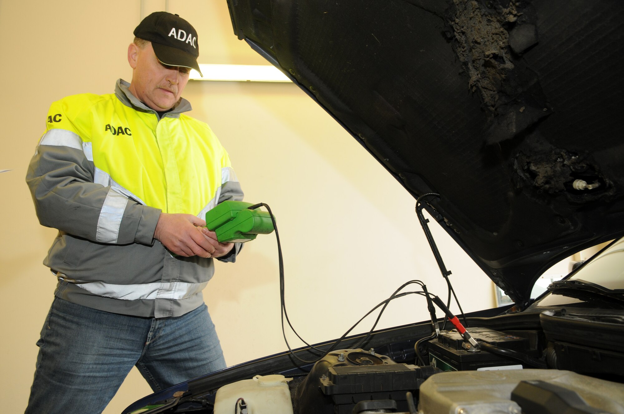 SPANGDAHLEM AIR BASE, Germany – Herbert Fuss, ADAC representative, tests the voltage of a car battery during a winter check Oct. 23. ADAC, a German auto club similar to the American Automobile Association, visited the base and partnered with the 52nd Fighter Wing Safety Office to perform free inspections on privately owned vehicles to identify potential hazards before winter driving conditions arrive. (U.S. Air Force photo/Staff Sgt. Benjamin Wilson)