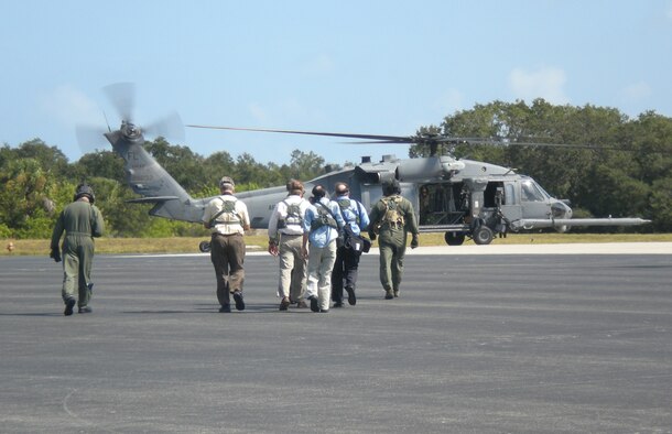 CAPE CANAVERAL AIR FORCE STATION, Fla. - Twenty five members of the media from central Florida and Georgia attended media day, Oct. 25, 2010, to help gain momentum for Central Florida's Air Force Week, which runs through Halloween, celebrating America's Airmen. The Air Force Reserve's 920th Rescue Wing from Patrick Air Force Base, flew the media around CCAFS and its neighbor, Kennedy Space Center in HH-60G Pave Hawks and an HC-130 King. Space shuttle Discovery was part of the sites as it prepares for lift off Nov. 1. The Rescue Wing Airmen had the chance to showcase thier role as guardians of the astronauts during lift offs. (U.S. Air Force photo/Staff Sgt. Michele Gibson)