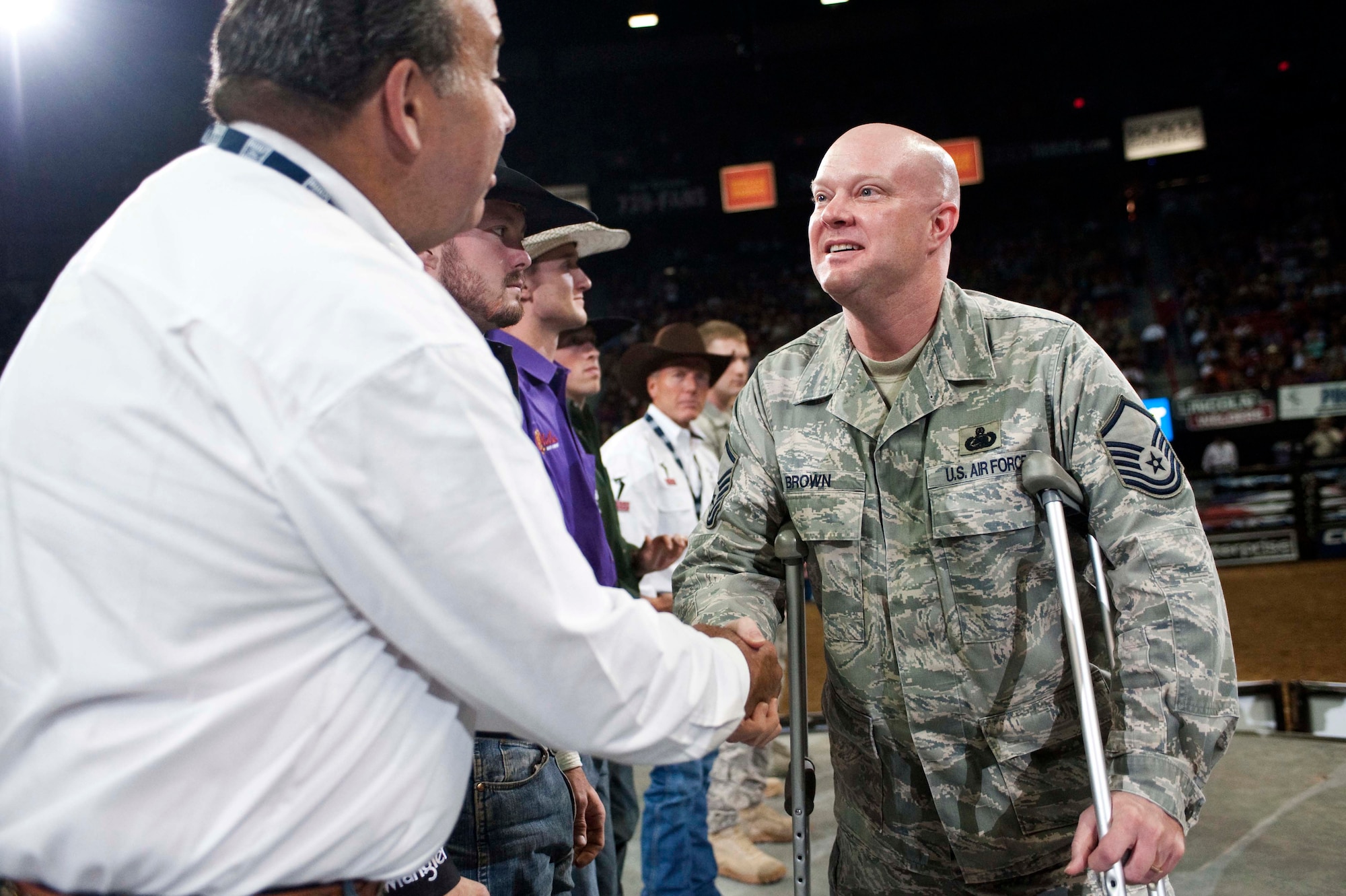 Master Sgt. Jeramie Brown shakes hand with a Wrangler representative during the Professional Bull Riders World Finals at the Thomas & Mack Center in Las Vegas Oct. 22. Sergeant Brown, who is assigned to the 99th Air Base Wing public affairs office, was one of several Airmen from Nellis Air Force Base who were honored for their service during Air Force night.  (U.S. Air Force photo/Tech. Sgt. Michael R. Holzworth)