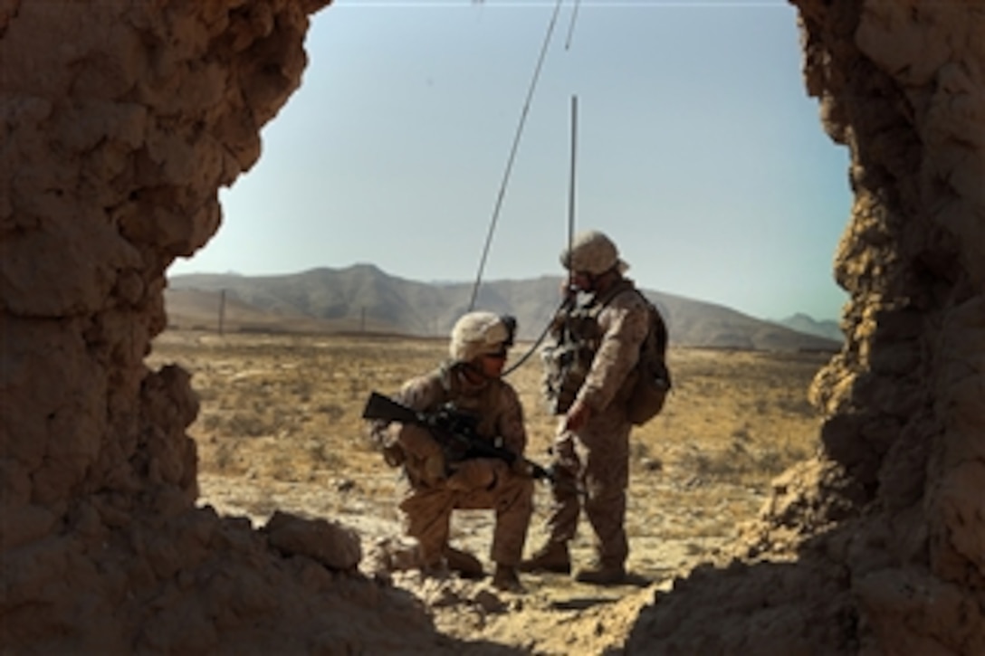 Sgt. Aaron Segovia, a squad leader with India Battery, 3rd Battalion, 12th Marine Regiment, Regimental Combat Team 2, radios in their position during their patrol to the northern part of their area of operations in Kajaki on Sept. 29, 2010.  The Marines' mission was to search for any suspicious activity in that area.  