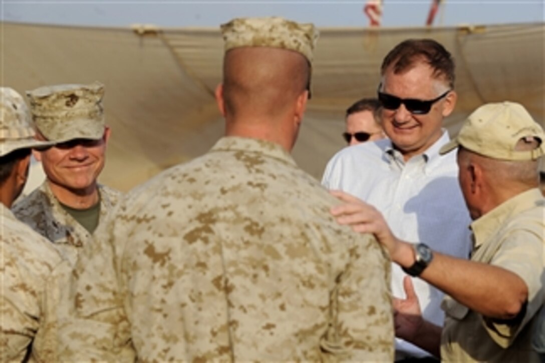 Deputy Secretary of Defense William J. Lynn III and Brig. Gen. James Nicholson share a laugh with a Marine instructor during a tour of the Joint Security Academy Southwest in Afghanistan, on Oct. 27, 2010.  The Joint Security Academy Southwest is a training facility where U.S. Marines and navy corpsmen train Afghan soldiers and police during an eight-week course covering explosive ordinance disposal, medical, driving and marksmanship among other things.  