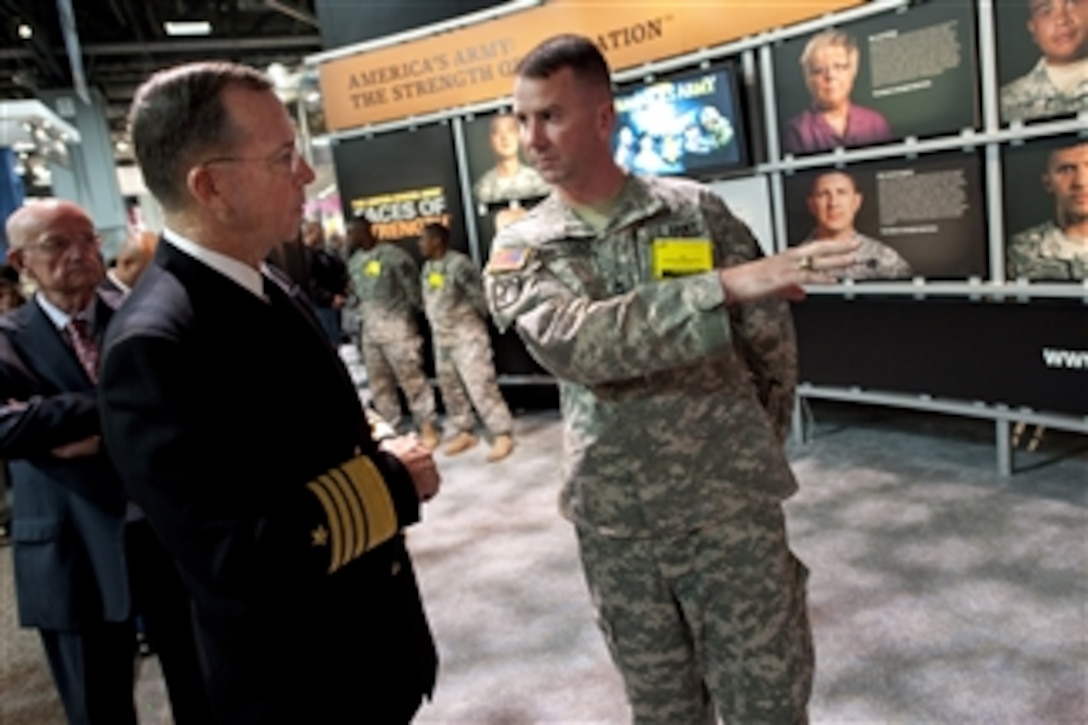 Chairman of the Joint Chiefs of Staff Adm. Mike Mullen, U.S. Navy, speaks with U.S. Army Sgt. 1st Class George J. Kirkpatrick at the 60th Annual Association of the U.S. Army Meeting and Exposition at the Walter E. Washington Convention Center in Washington, D.C., on Oct. 27, 2010.  