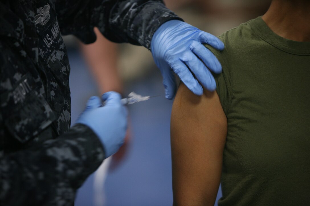A corpsman from Naval Air Station, Joint Reserve Base, Belle Chasse, administers a flu shot to a Marine at MarForRes Headquarters Oct. 27, 2010.  Vaccination is mandatory for all service members.