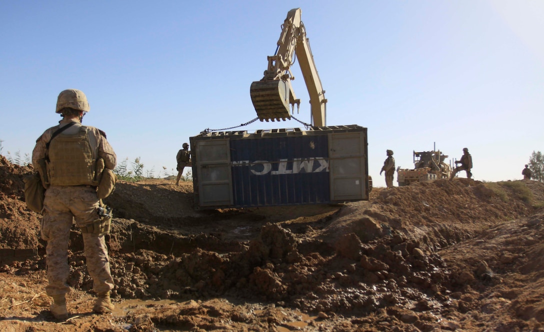 U.S. Marine 1st Lt. Elizabeth Stroud, engineer platoon commander, Engineer Company, Combat Logistics Battalion 3, 1st Marine Logistics Group (Forward), monitors the progress of a bridge construction in Trakh Nawa, Afghanistan, Oct. 27. The bridge will be used for military and civilian transport in the area.