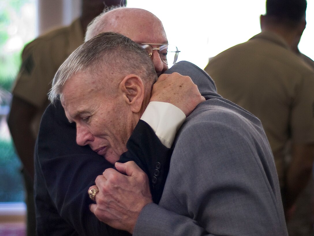 Retired Lt. Col. Gregory K. Manary (foreground) and former Sgt. Richard Crepeau, who served together in 3rd Force Reconnaissance Company in Vietnam, share an embrace after an awards ceremony at the MacDill Air Force Base officers club Oct. 27. Crepeau was one of five Marines from the unit who received awards for valor in combat operations conducted more than 43 years ago.