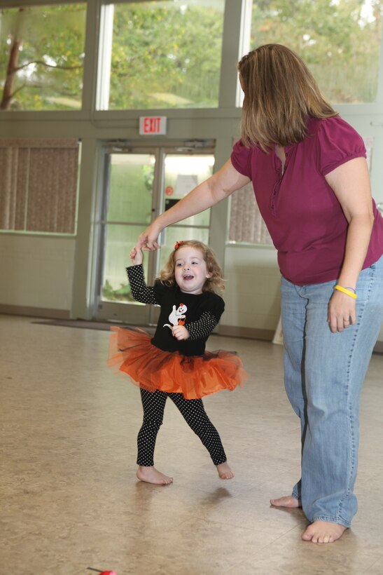 Jillian Hays (left) twirls with her mother during a Kindermusik class at Tarawa Terrace Community Center in the Marine Corps Base Camp Lejeune housing area, Oct. 28.  Kindermusik is a music and movement program that teaches children a number of skills crucial to child development.