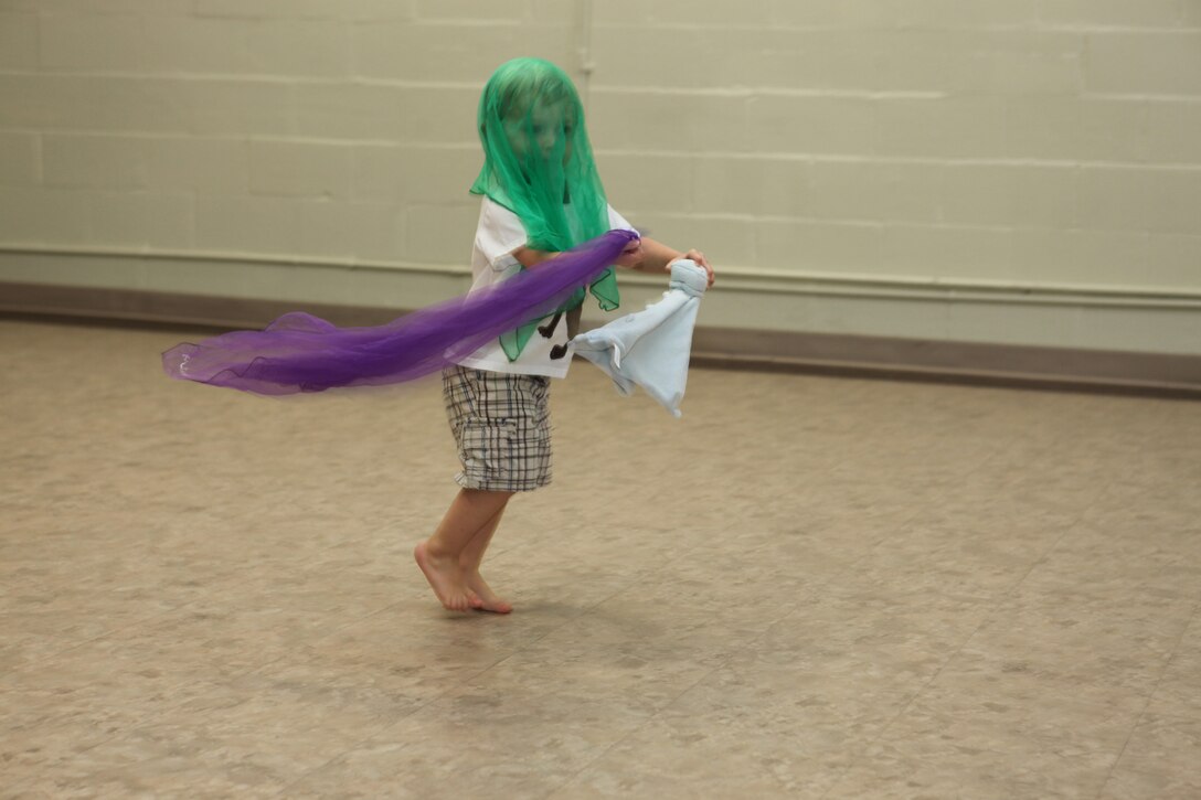 Ethan Rule runs around with colorful scarves and his blanket during a Kindermusik class at Tarawa Terrace Community Center in the Marine Corps Base Camp Lejeune housing area, Oct. 28.  The class was open to children ages 18 months to 3 years old, and incorporated music, dancing and games.