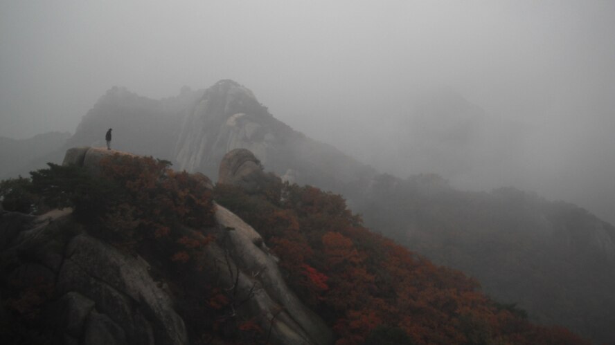 A lone hiker looks down from a peak near Jaunbong in Bukhansan National Park, Republic of Korea. (U.S. Air Force photo/Staff Sgt. Eric Burks)