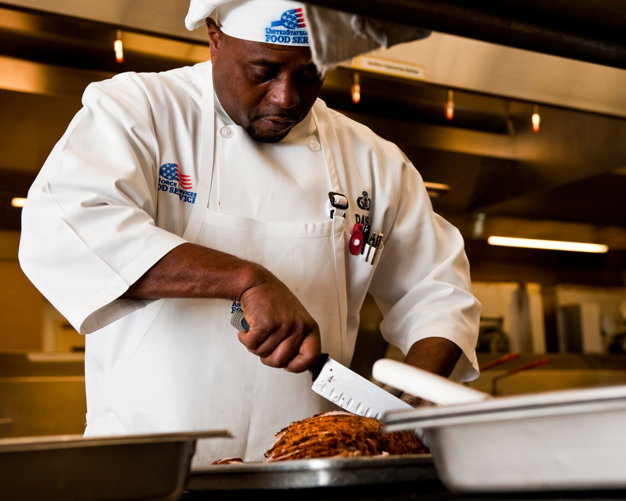 JOINT BASE ELMENDORF-RICHARDSON, Alaska –Tyrone Davis, 673d Force Support Squadron cook, prepares afternoon entrées for Iditarod Dinning Facility patrons, October 25. (U.S. Air Force photo/Airman1st Class Jack Sanders)