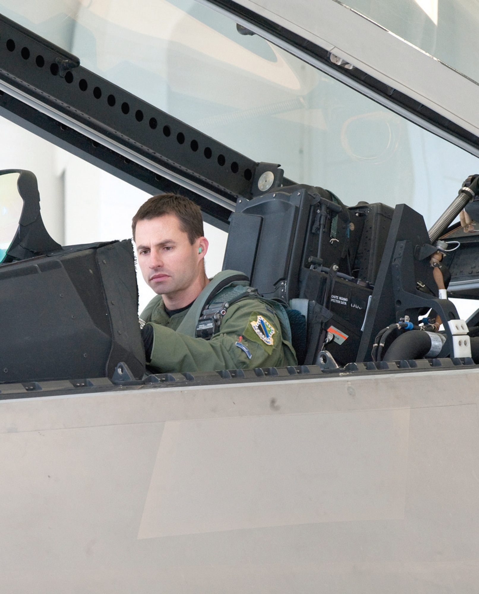 JOINT BASE ELMENDORF-RICHARDSON, Alaska – Captain Graham "Jinx" Stewart, 525 Fighter Squadron, gets ready for a flight Oct 25. Monday was the first day the 525 FS used their brand new F-22 aircraft shelters. The 15 attached hangers help improve their maintenance capability by sheltering the jets from the winter elements. (U.S. Air Force photo/ Senior Airman Kristin High)