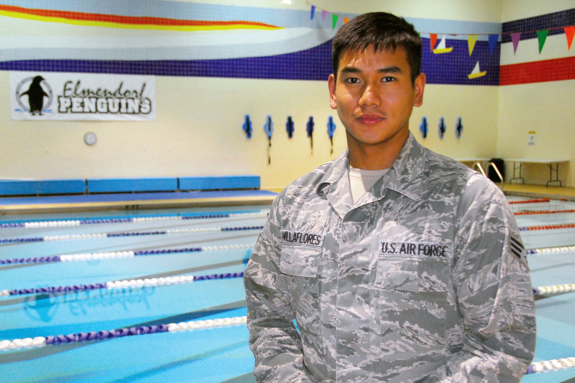 Senior Airman Ferdie Villaflores, 176th Operations Support Squadron, stands by the Elmendorf Fitness Center pool where he helped rescue a drowning boy during open swim, Sept. 29. (Alaska Army National Guard photo/Pfc. Karina Paraoan)