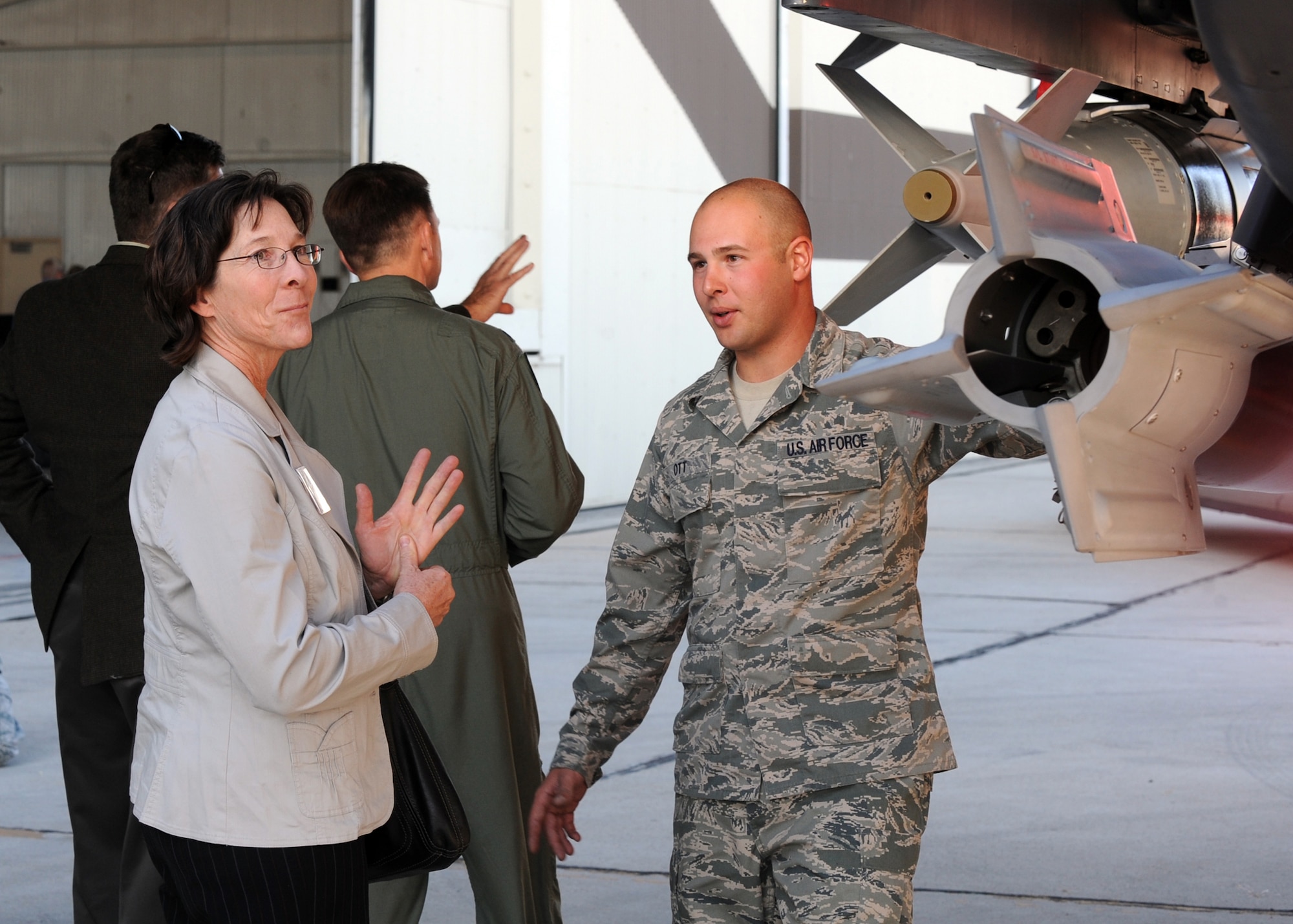 MOUNTAIN HOME AIR FORCE BASE, Idaho -- Senior Airman John Ott, 366th Aircraft Maintenance Squadron, explains the capabilities of an F-15E Strike Eagle to Cindy Bond, 366th Operations Support Squadron honorary commander, during the Honorary Commander Change of Command Ceremony Oct. 22 in hangar 1331. The Honorary Commander program is designed to increase the understanding of the 366th Fighter Wing and Air Force missions by pairing community leaders with the wing’s leaders to forge new relationships. (U.S. Air Force photo by Senior Airman Debbie Lockhart)
