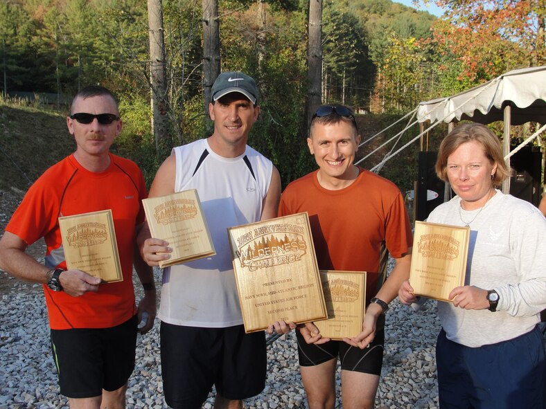FAYETTEVILLE, W.V. – The 2010 Wilderness Challenge team ‘Mixed Bag of Nuts’ (left to right) Maj. Brian Payne, Maj. Bryan Eckart, Maj. Bill Courtemanche and Capt. Keri Walker pose for a photo with their plaques after completing the challenge. The team took 2nd place in the Air Force competition after completing a 5.1-mile mountain run, 13-mile whitewater rafting race, 11-mile mountain bike race, 14-mile mountain hike/run and a 7-mile duckie/kayak race. (Courtesy photo)