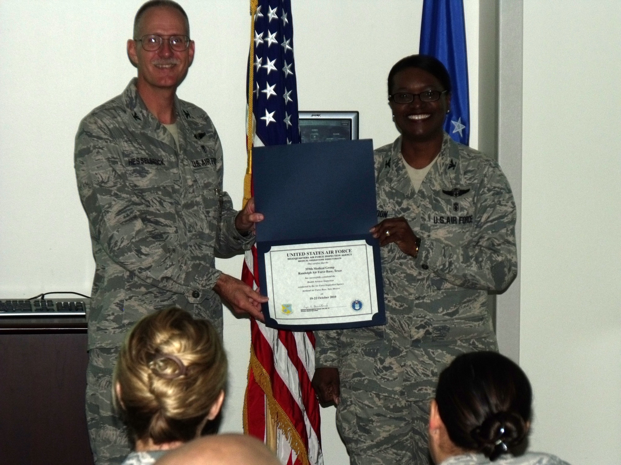 Col. Roger Hesselbrock, team chief and director of medical operations for the Air Force Inspection Agency, presents a Health Services Inspection certification Oct. 22, at Randolph Air Base, Texas, to Col. Soledad Lindo-Moon, commander, 359th Medical Group, recognizing her team's professional and dedicated staff members for earning an excellent HSI rating. (Courtesy photo)


