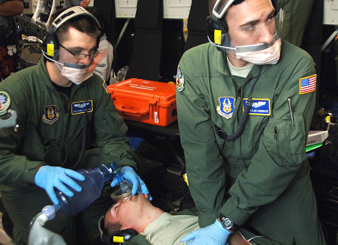 KAILUA-KONA, Hawaii  - Staff Sgt. Daniel Nelson and Senior Airman Dylan Congrove demonstrate CPR on Cadet 2nd Class Timothy Reid during a medical training scenario aboard a C-17 Globemaster III Oct. 7. The Airmen are Reservists assigned to the 446th Aeromedical Evacuation Squadron at Joint Base Lewis-McChord, Wash. Cadet Reid is assigned to Cadet Squadron 04 at the Air Force Academy in Colorado Springs, Colo., and hopes to go into the medical field after he graduates. (U.S. Air Force photo/Staff Sgt. Raymond Hoy)