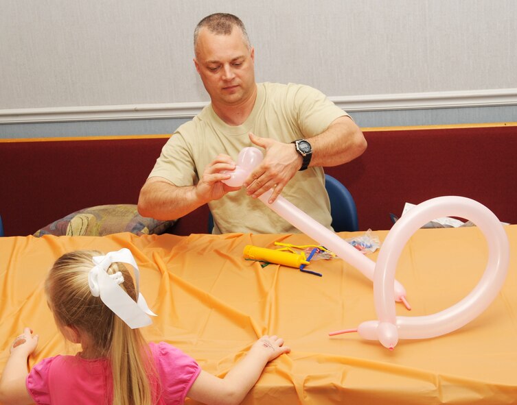 BARKSDALE AIR FORCE BASE, La. -- Chaplain (Major) Kristoffer Cox, 2nd Bomb Wing chaplain, makes a balloon animal during the third annual Trunk-or-Treat event held at Chapel 2. The activity was held to give kids an alternative way to celebrate Halloween. (U.S. Air Force photo/Airman 1st Class Sean Martin)
