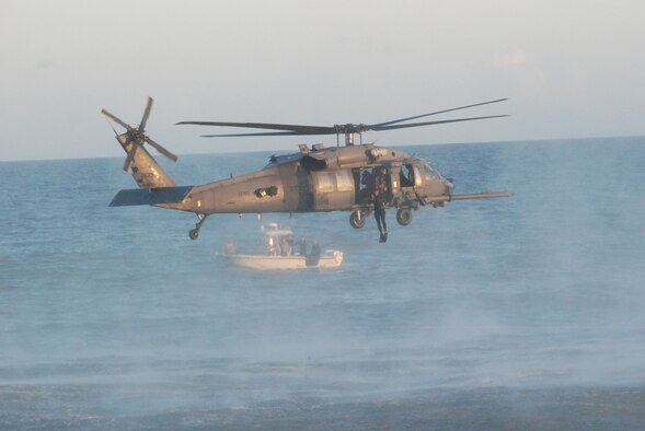 PATRICK AIR FORCE BASE, Fla. - Air Force Reserve pararescuemen Staff Sgt. Dan Warren jumps out of a 920th Rescue Wing HH-60G Pave Hawk helicopter during a demonstration for Air Force Week at the Cocoa Beach Pier. This demonstration showcases one of the many life-saving skill sets of the 920th RQW pararescuemen; the others are expert SCUBA diver, mountaineer, marksman and parachutist. These Rescue Reservists will be performing during the Cocoa Beach Air Show, Oct. 30-31, 2010. (U.S. Air Force photo/Staff Sgt. Leslie Kraushaar) 

