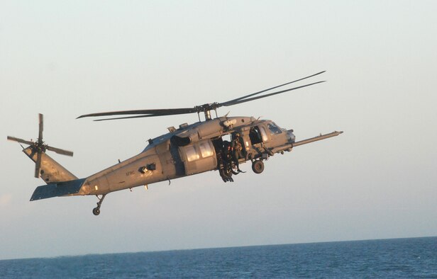 PATRICK AIR FORCE BASE, Fla. - Reserve pararescuemen from the 920th Rescue Wing here get ready to jump out of an HH-60G Pave Hawk helicopter during a demonstration at the Cocoa Beach Pier -  Air Force Week show center Wednesday evening. The PJs are gearing up for a full weekend of showing the public their water rescue skills during the 2010 Cocoa Beach Air Show, Oct. 30-31. The 920th RQW PJs are an elite bunch of men with expert skills ranging from expert SCUBA diver, mountaineer, marksman and parachutist. They also must obtain and maintain emergency medical technician-paramedic qualifications throughout their career. (U.S. Air Force photo/Staff Sgt. Leslie Kraushaar) 


