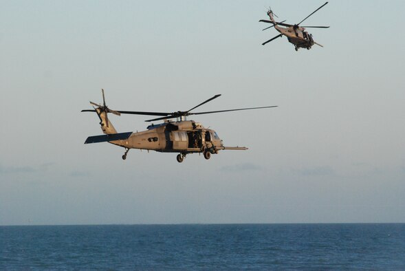 PATRICK AIR FORCE BASE, Fla. - Two Air Force Reserve HH-60G Pave Hawk helicopters from the 920th Rescue Wing here perform during a demonstration of their rescue capabilities Wednesday evening at the Cocoa Beach Pier - show center for Air Force Week. The Rescue Reservists here will be performing during the Cocoa Beach Air Show October 30-31, 2010. Reserve pararescuemen showcase their life-saving skills by jumping into the water to simulate ways they would extract a person in distress. (U.S. Air Force photo/Staff Sgt. Leslie Kraushaar) 
