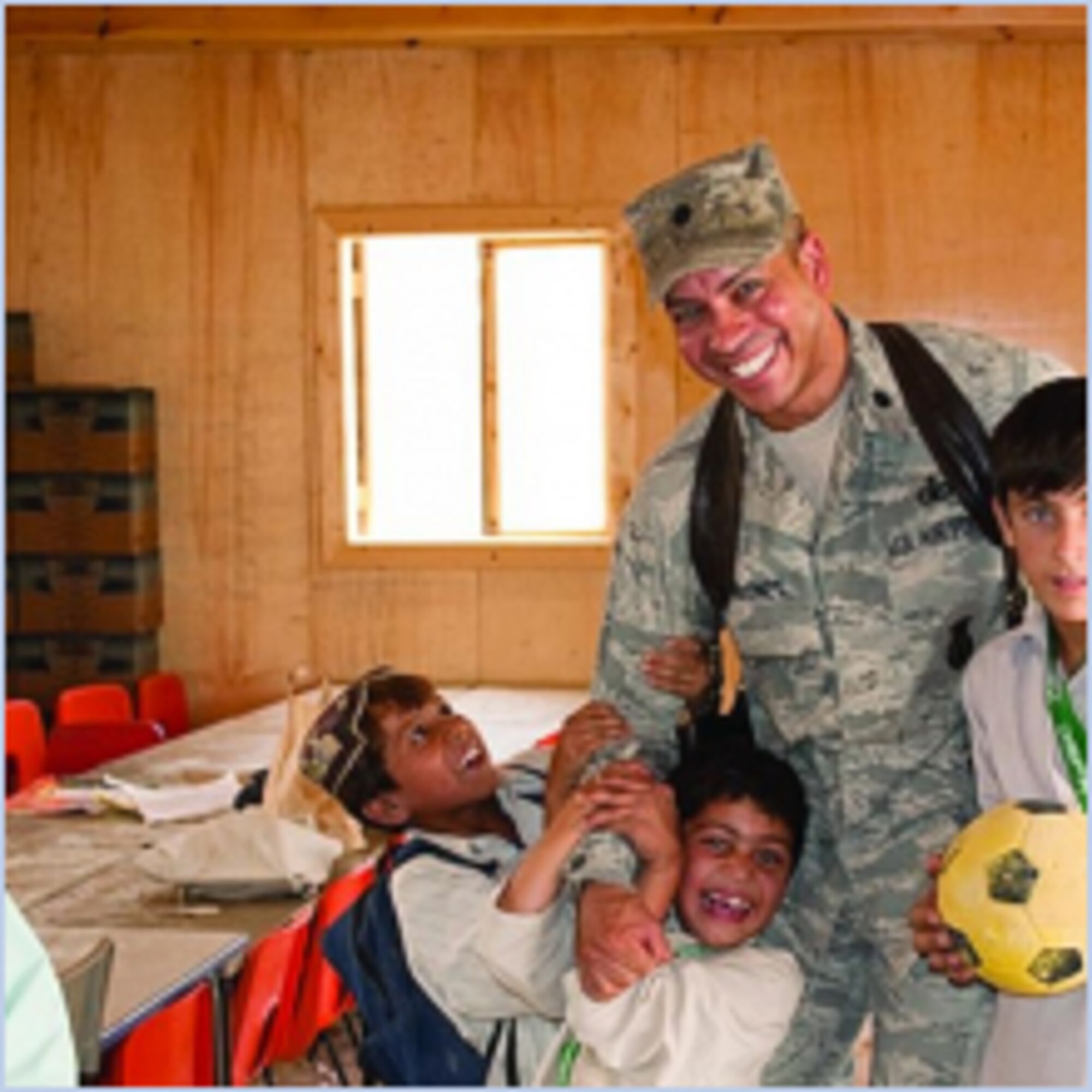 Lt. Col. Anthony Maisonet, 75th Security Forces commander, volunteers with Afghan children at their school that the Slovakian engineers built while he was deployed at Kandahar Air Field in Afghanistan. (courtesy photo)