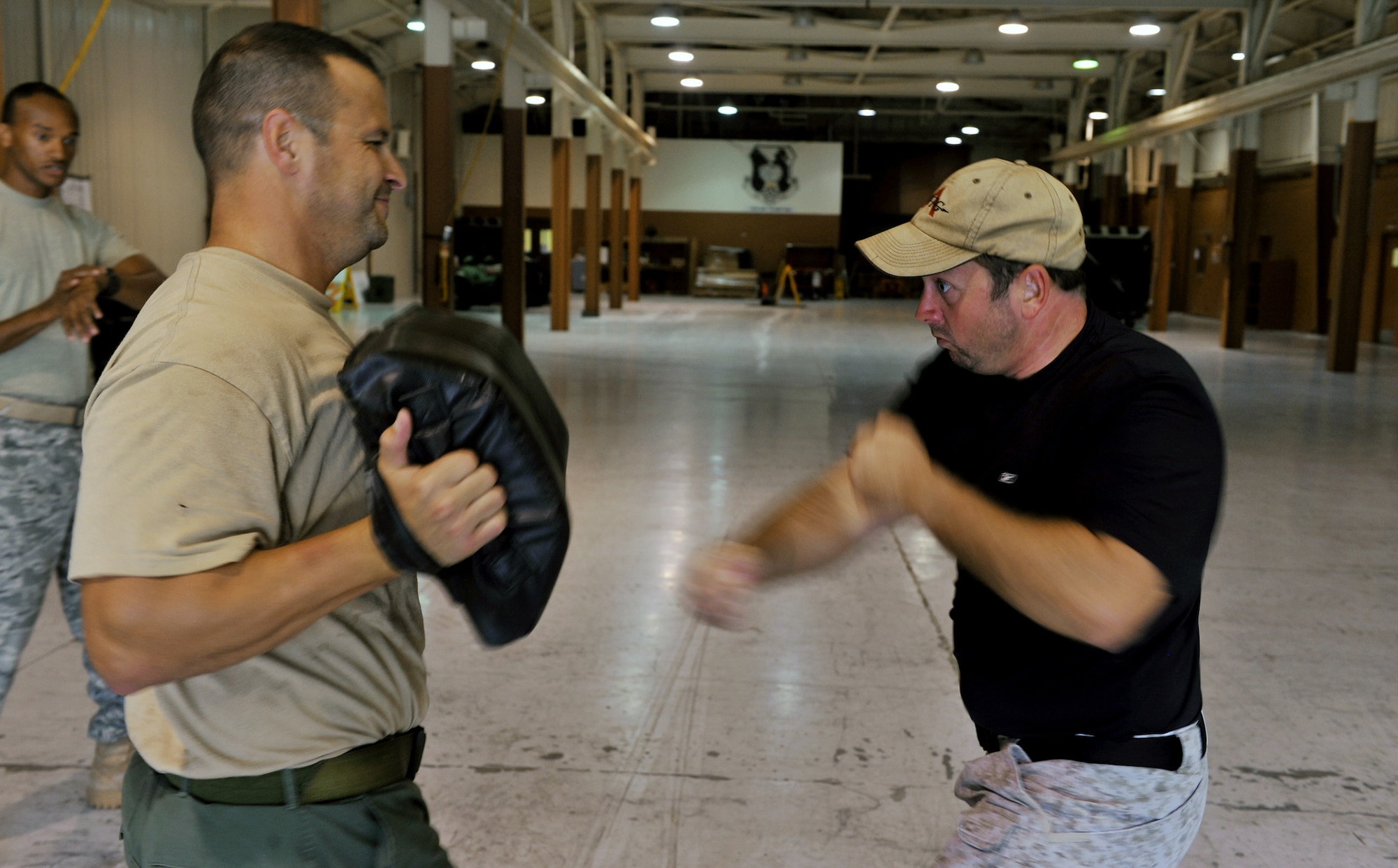 Lt. Joseph Dukes punches a bag held by Steve Jarrmaillo during a Krav Maga timed combat session Oct. 14, 2010 at Moody Air Force Base, Ga. One part of training for Krav Maga is conditioning, before practicing a technique, instructors lead members through a vigorous conditioning session. Lieutenant Dukes is a Lowndes County Sheriff's Department Special Weapons and Tactics team leader and training coordinator. Mr. Jarrmaillo is a Lowndes County Sheriff's Department reserve deputy. (U.S. Air Force photo/Airman 1st Class Joshua Green)