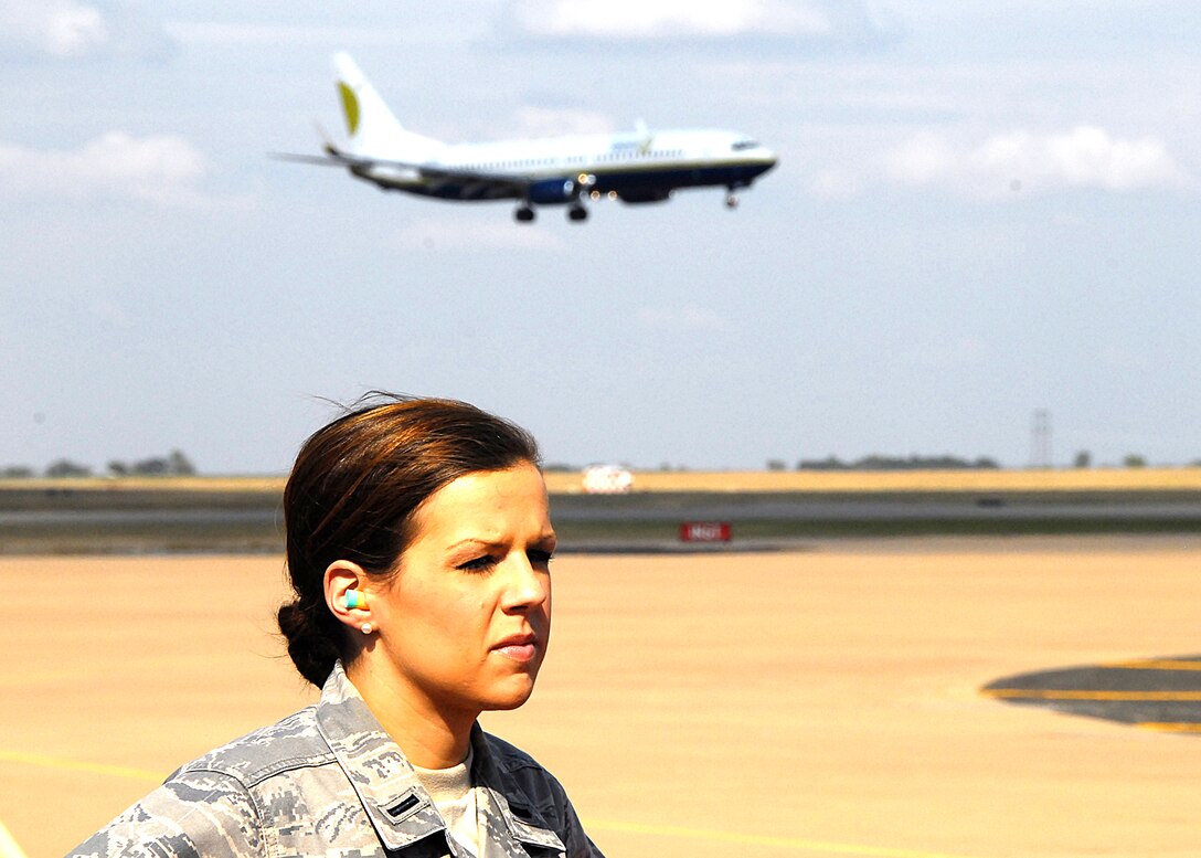 First Lt. Mary Hossier, a protocol officer at the 80th Flying Training Wing, waits on the flightline Oct. 21 as the aircraft carrying NATO Air Chiefs prepares to land. The Air Chiefs made a quick stop at Sheppard as part of a tour to several locations in the United States. (U.S. Air Force photo/Harry Tonemah)