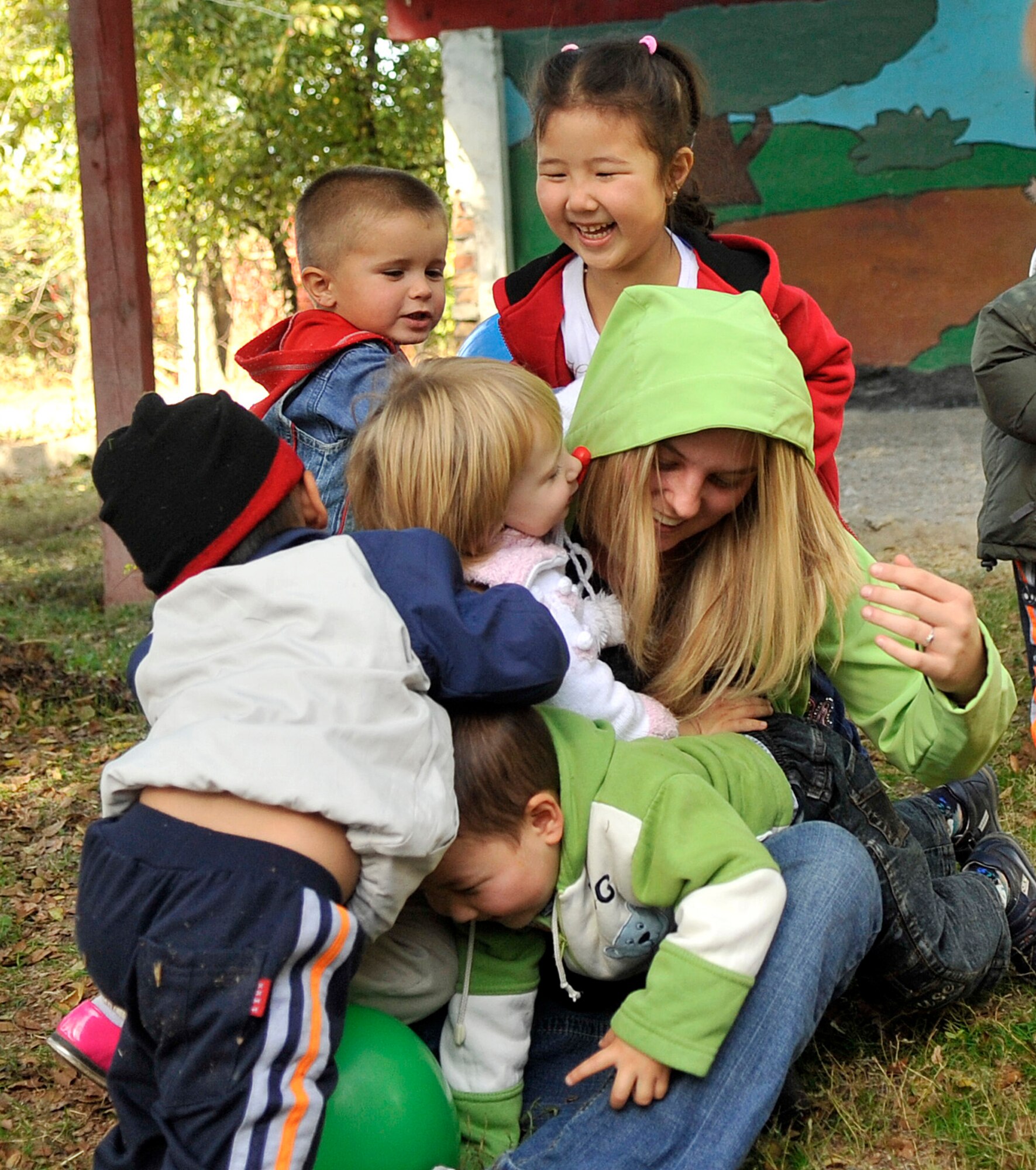 Airman 1st Class Jessica Wilson plays with several kids Oct. 18, 2010, at the Solnyshko school near Vasilievka, Kyrgyzstan. (U.S. Air Force photo/Staff Sgt. J.G. Buzanowski)