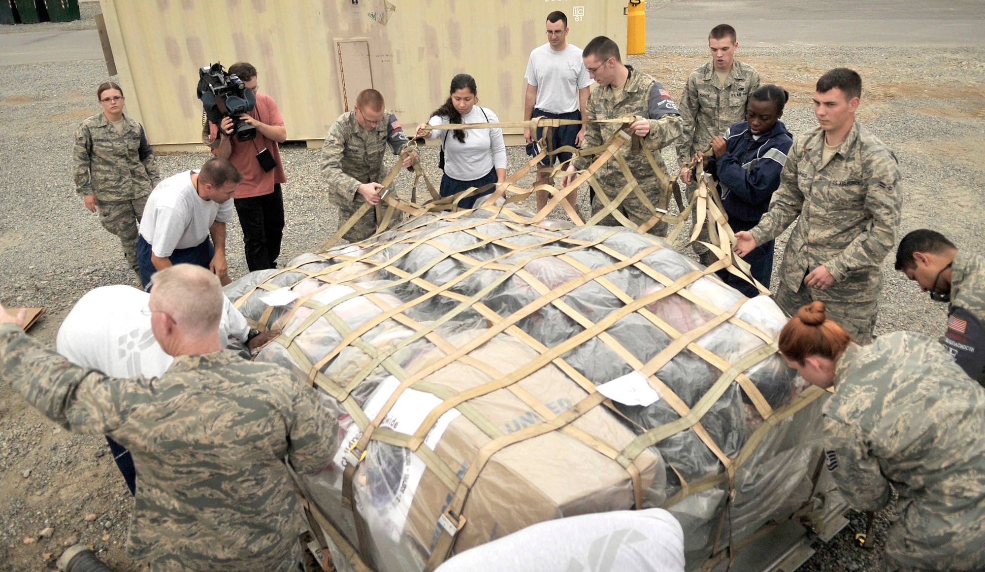 Airmen at the Manas Transit Center, Kyrgyzstan, unpack a pallet of coats and blankets Oct. 17, 2010, for the Solnyshko school near the town of Vasilievka, Kyrgyzstan. (U.S. Air Force photo/Staff Sgt. J.G. Buzanowski)