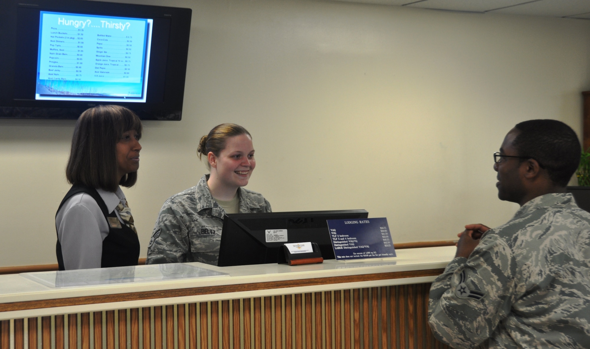 Ms. Andrea Hernandez, 325th Force Support Squadron guests services representative, and Senior Airman Rachel Beltz, 325th FSS guest service representative, assist an incoming guest at the Sand Dollar Inn at Tyndall Air Force Base.  