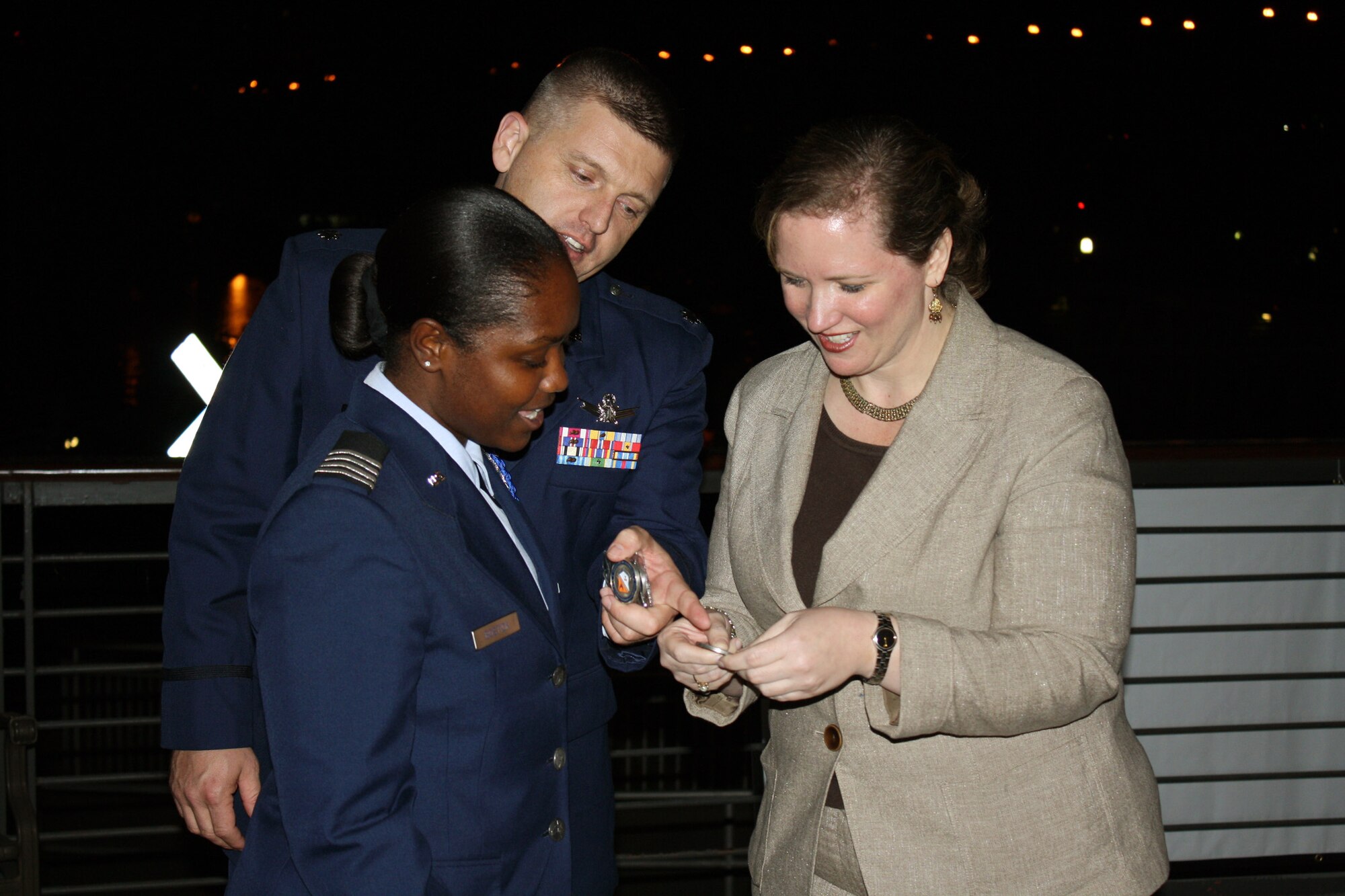 Undersecretary of the Air Force Erin C. Conaton accepts the University of Tennessee ROTC coin from Kena Bostick and Lt. Col. Mike Angle, following an Air Force Smart Operations for the 21st Century awards dinner Oct. 14, 2010, honoring Knoxville companies who support Air Force programs at the university. Ms. Bostick is a cadet wing commander. Colonel Angle is the commander of Air Force ROTC Det. 800. (U.S. Air Force photo/Lt. Col. Cindi Feldwisch)