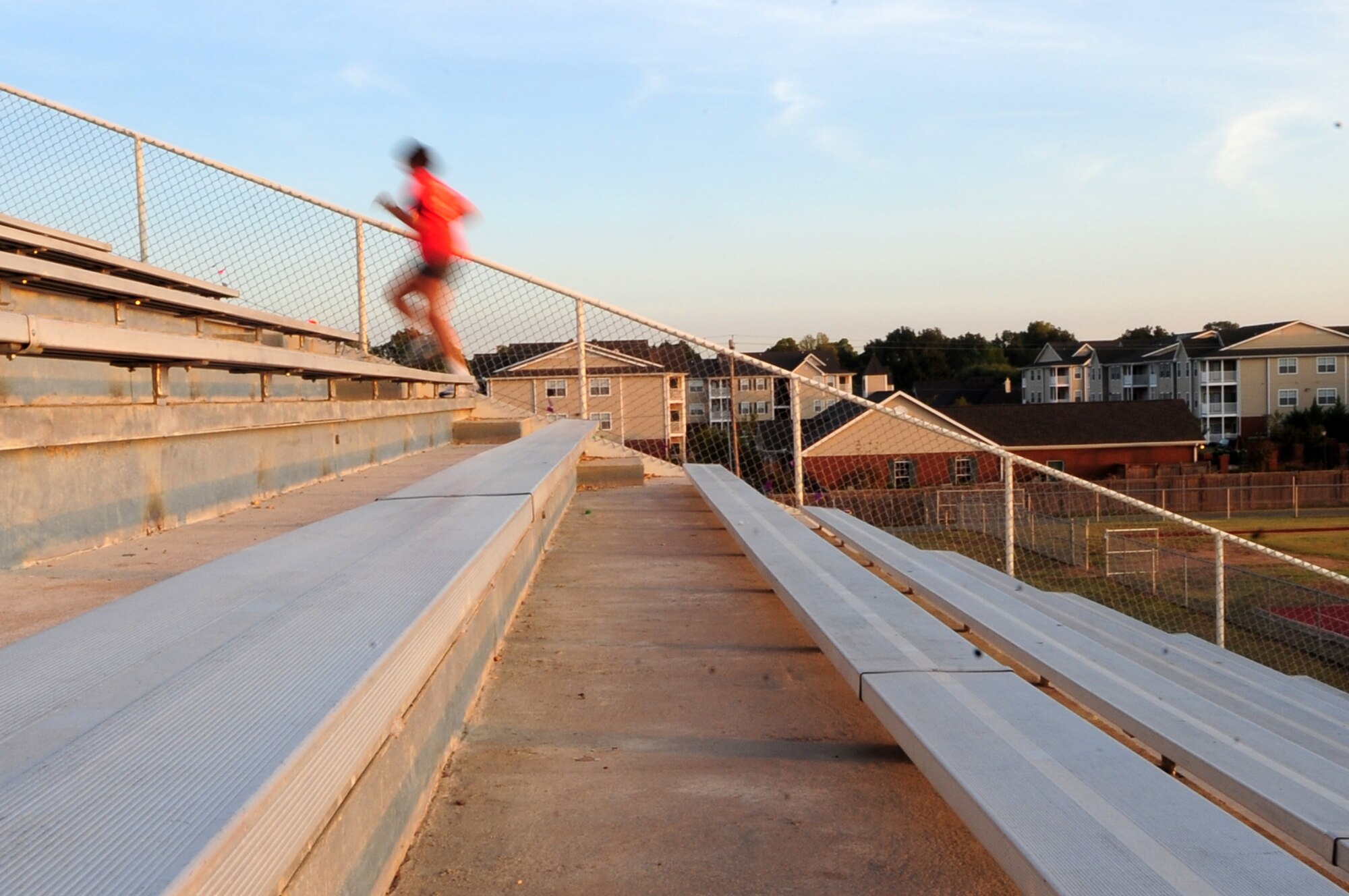 SHREVEPORT, La. -- Capt. Barbara McDonald, 2nd Medical Operations Squadron, sprints up stadium stairs as part of the 'rookie runner' program at Captain Shreve Stadium Oct. 27. Tedric Johnson of the Health and Wellness Center runs the program designing dynamic workouts targeted to help pass a physical training test. (U.S. Air Force photo/Senior Airman Joanna M. Kresge)