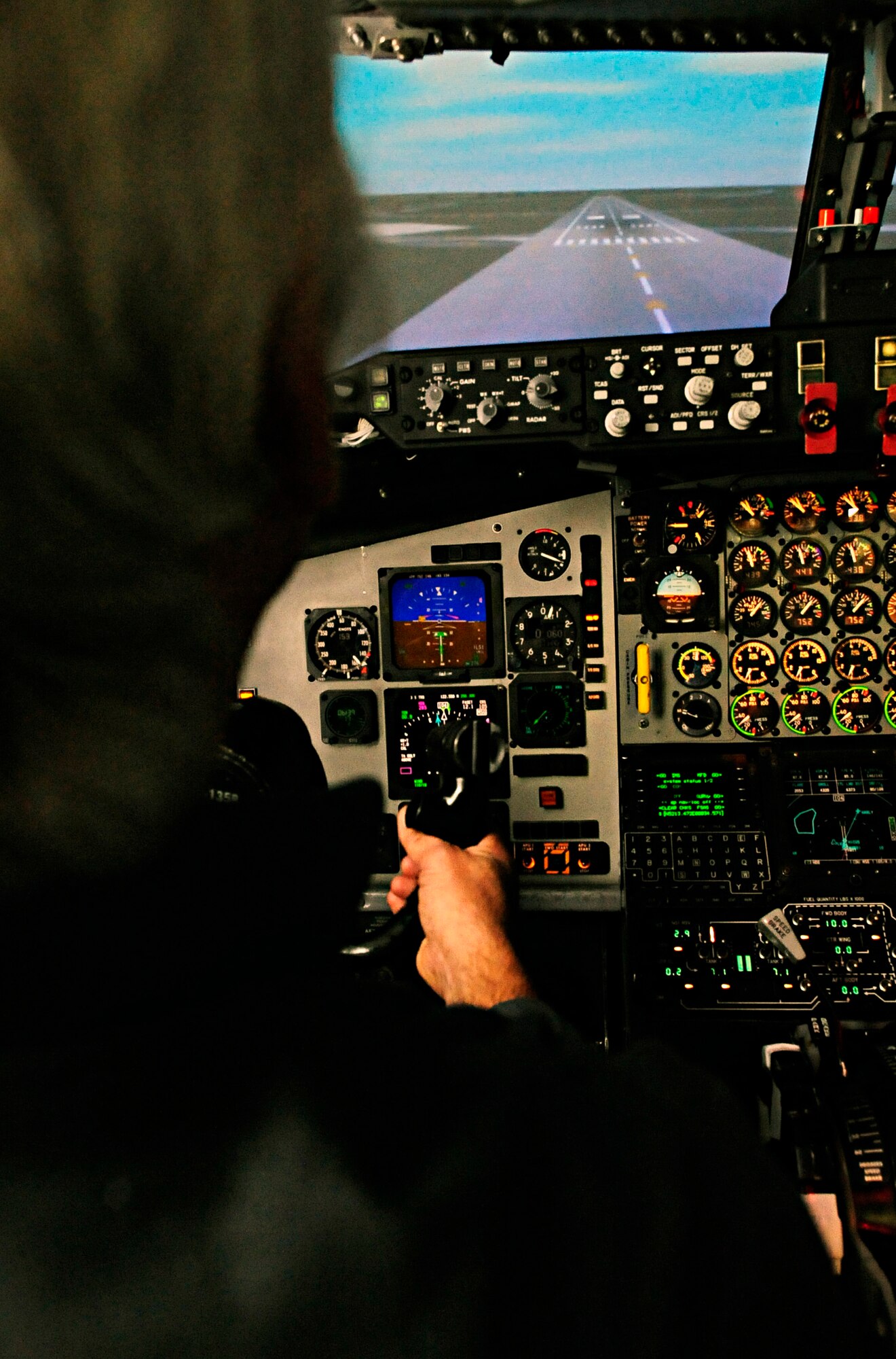 RAF MILDENHALL, England -- Michael Jones, a member of the Anglia Gliding Club, prepares to do a touch-and-go in the flight simulator Oct. 22. The members of the gliding club were allowed a few minutes each in the simulator to experience how KC-135s move in flight. (U.S. Air Force photo/Senior Airman Ethan Morgan)