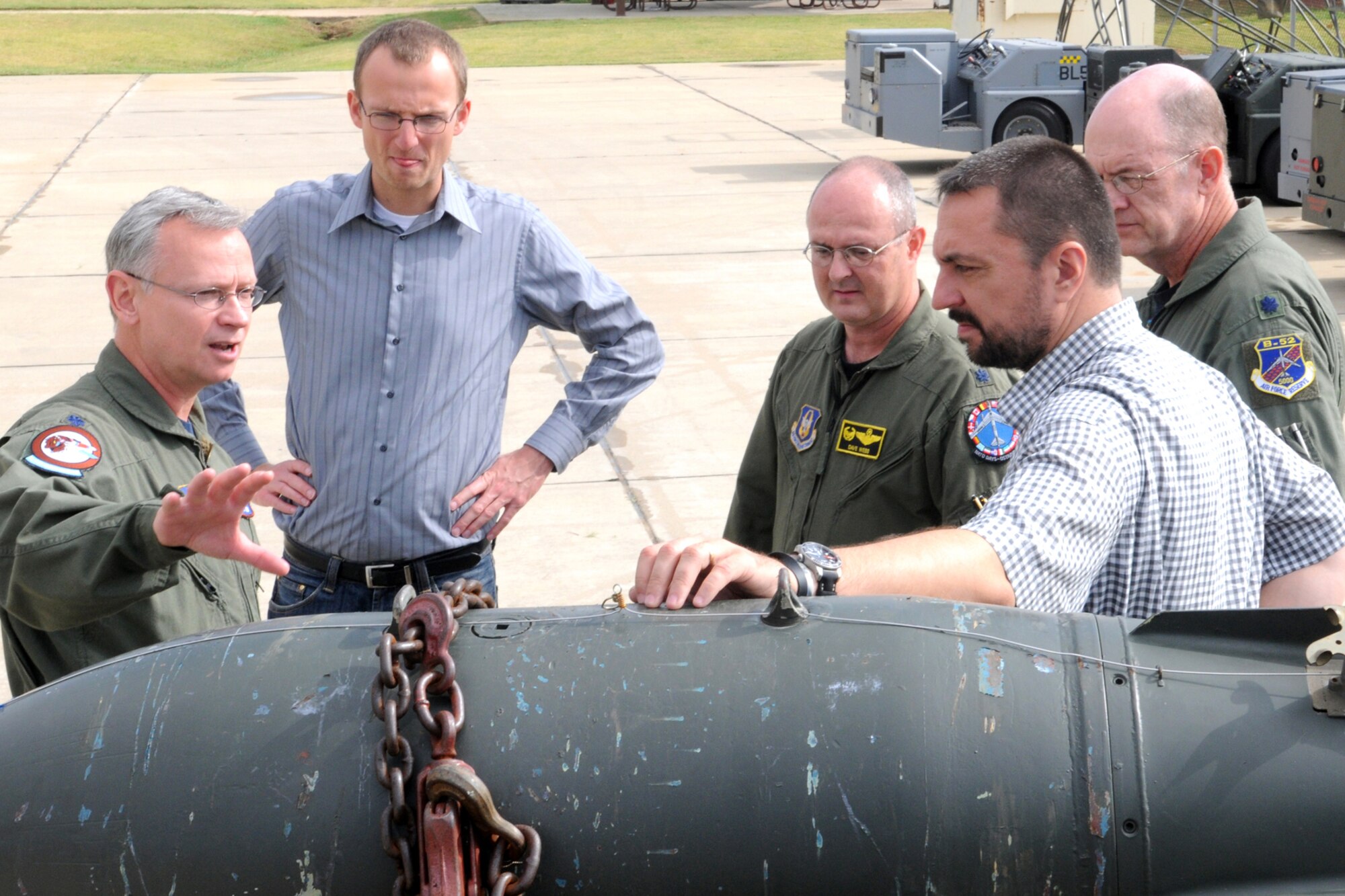 Lt. Cols. Dave Webb, 917th Operations Support Flight commander, and Bruce Gootee, 917th OSF director of operations, look on as Lt. Col. Joseph Jones, 93rd Bomb Squadron commander, talks about the capabilities of the M117 700 pound general purpose bomb with Dr. Petr Zlatohlavek, North Atlantic Treaty Organization Information Center executive chairman, and Zbynek Pavlacik, Jagello 2000 Association chairman, during their visit to the 917th Wing, Barksdale Air Force Base, La., on Oct. 26, 2010. The Jagello 2000 Association is a top Czech Republic nonprofit, nongovernmental organization in the field of public and defense diplomacies, focusing on the presentation of NATO and security politics for the general public. It is also the main sponsor of the NATO Days in Ostrava air show, which was held Sept. 18-19, 2010, in Ostrava, Czech Republic. The 917th Wing supplied a B-52H Stratofortress and personnel in support of the air show, which marked the first-time a B-52 visited the Czech Republic. (U.S. Air Force photo/Master Sgt. Greg Steele)