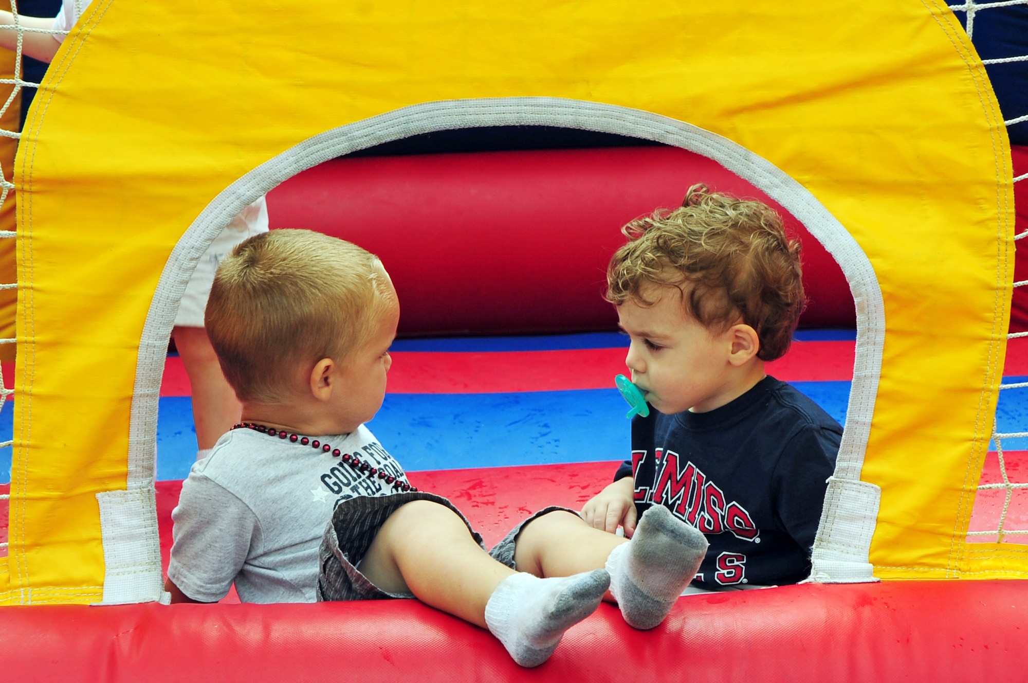 BARKSDALE AIR FORCE BASE, La. -- (Left to right) Braydon, 2, son of Staff Sgt. Matthew Johnson, 608th Air Communications Squadron, and Finn Patrick, 2, from Bossier City play in a bouncy house together during the fall festival held outside the Stripes Club Oct. 23. The fall festival featured games, sponsor booths, food and a live performance by the band Front Cover featuring Mark Scroggins. (U.S. Air Force photo/Senior Airman Joanna M. Kresge)