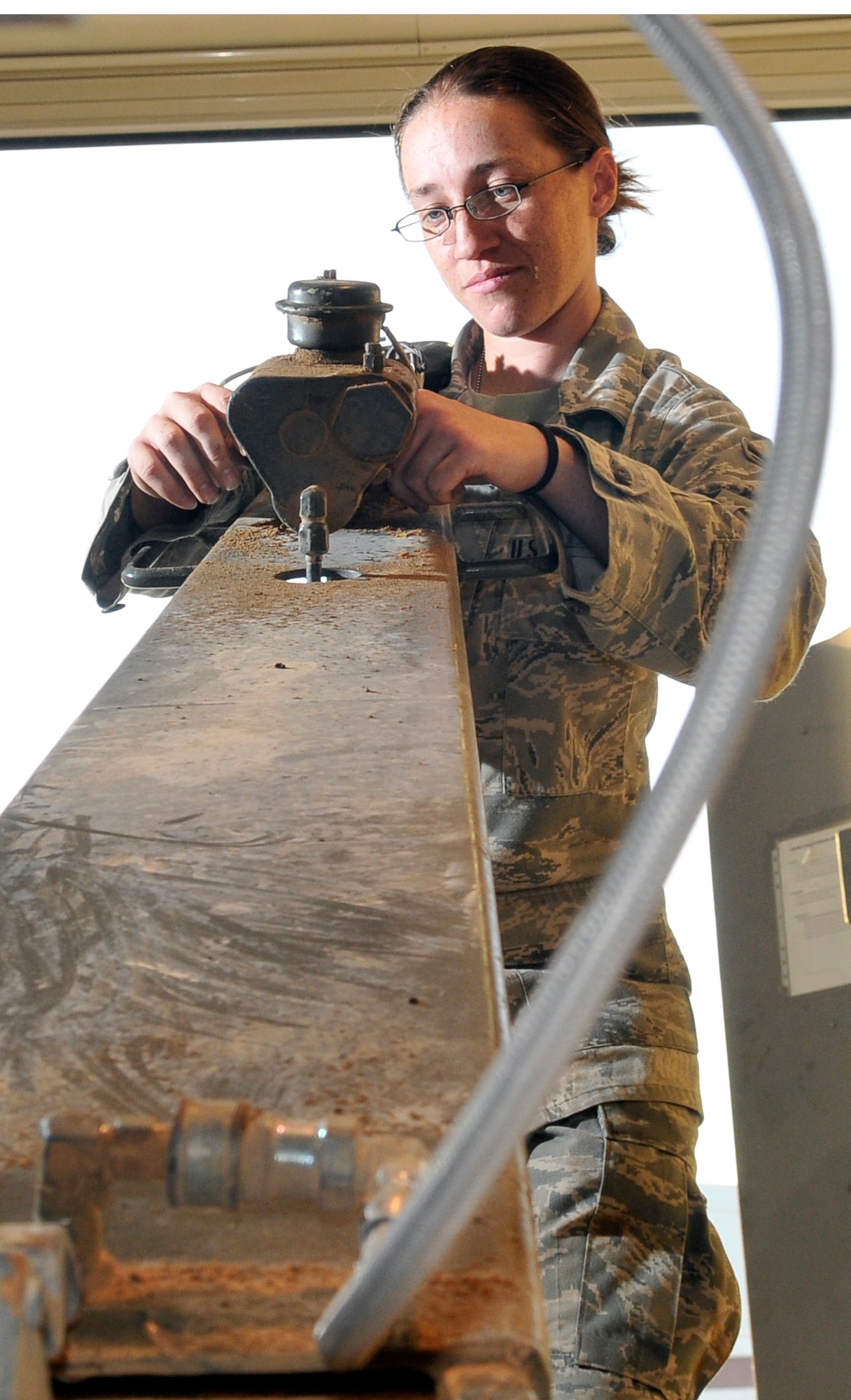 Airman 1st Class Caitlyn Mock, 332nd Expeditionary Maintenance Squadron munitions maintenance support crew member, inspects a draw bar of a 141 Munitions Delivery Trailer for corrosion Oct. 14, 2010, Joint Base Balad, Iraq. The 141 MDT can be configured to deliver any form of munitions to the flightline. Airman Mock is a native of Phoenix, deployed from Misawa Air Base, Japan. (U.S. Air Force photo/Tech. Sgt. Phillip Butterfield)