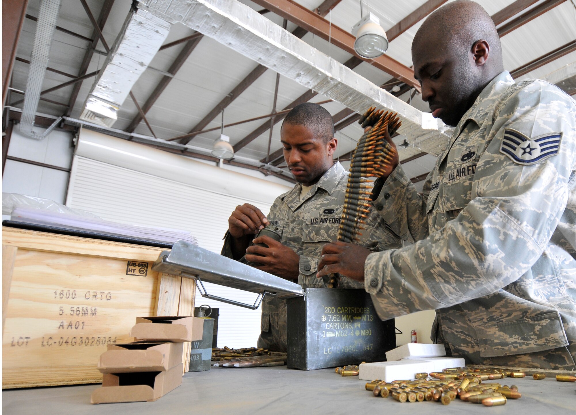 Staff Sgts. Gregory Simpson (left), and Terance Douglas, 332nd Expeditionary Maintenance Squadron munitions inspectors, sort and inspect excess ammunition and smoke grenades turned in from a unit Oct. 14, 2010, Joint Base Balad, Iraq. Air Force munitions technicians are required to inspect and account for all the munitions in their control once a year. Sergeant Simpson is a native of Daleville, Ala., and Sergeant Douglas is a native Philadelphia, both Airmen are deployed from Misawa Air Base, Japan. (U.S. Air Force photo/Tech. Sgt. Phillip Butterfield)