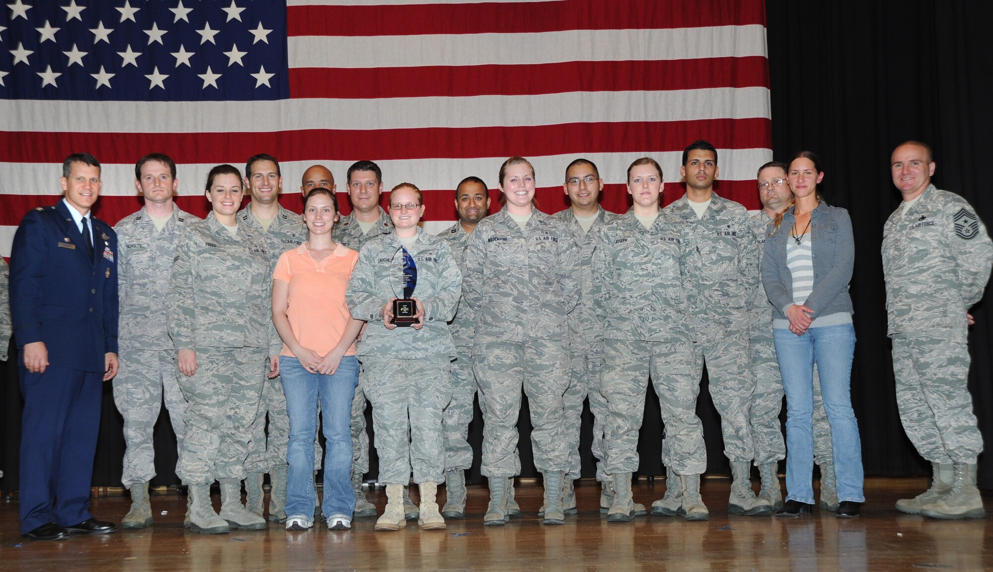 The 22nd Medical Group dental flight stand on stage after winning the award for “Best Team” during the Third Annual Quarterly Awards ceremony held at the Robert J. Dole Center Community Center ballroom, Oct. 22, 2010, McConnell Air Force Base, Kan.  The winners were recognized for providing sustained superior performance and distinguished themselves through personal and professional achievements. (U.S. Air Force photo/Airman 1st Class Andrea Salazar)