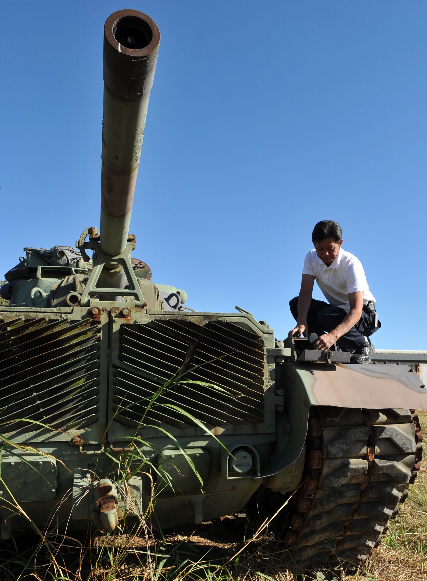 Victor Ambegia, Disposition Services Little Rock property disposal specialist, inspects the phone on an MA81 tank Oct. 27. Mr. Ambegia earned the Defense Logistics Agency Superior Civilian Service Award and the Secretary of Defense Global War on Terrorism Medal for his service and achievements during deployments to Afghanistan and Kyrgyzstan. (U.S. Air Force photo by Senior Airman Gul Crockett)