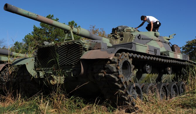 Mr. Victor Ambegia, Disposition Services Little Rock property disposal specialist, inspects the phone on an MA81 tank Oct. 27, 2010, at Little Rock Air Force Base, Ark. Mr. Ambegia earned the Defense Logistics Agency Superior Civilian Service Award and the Secretary of Defense Global War on Terrorism Medal for his service and achievements during deployments to Afghanistan and Kyrgyzstan. (U.S. Air Force Photo/Senior Airman Gul Crockett) 