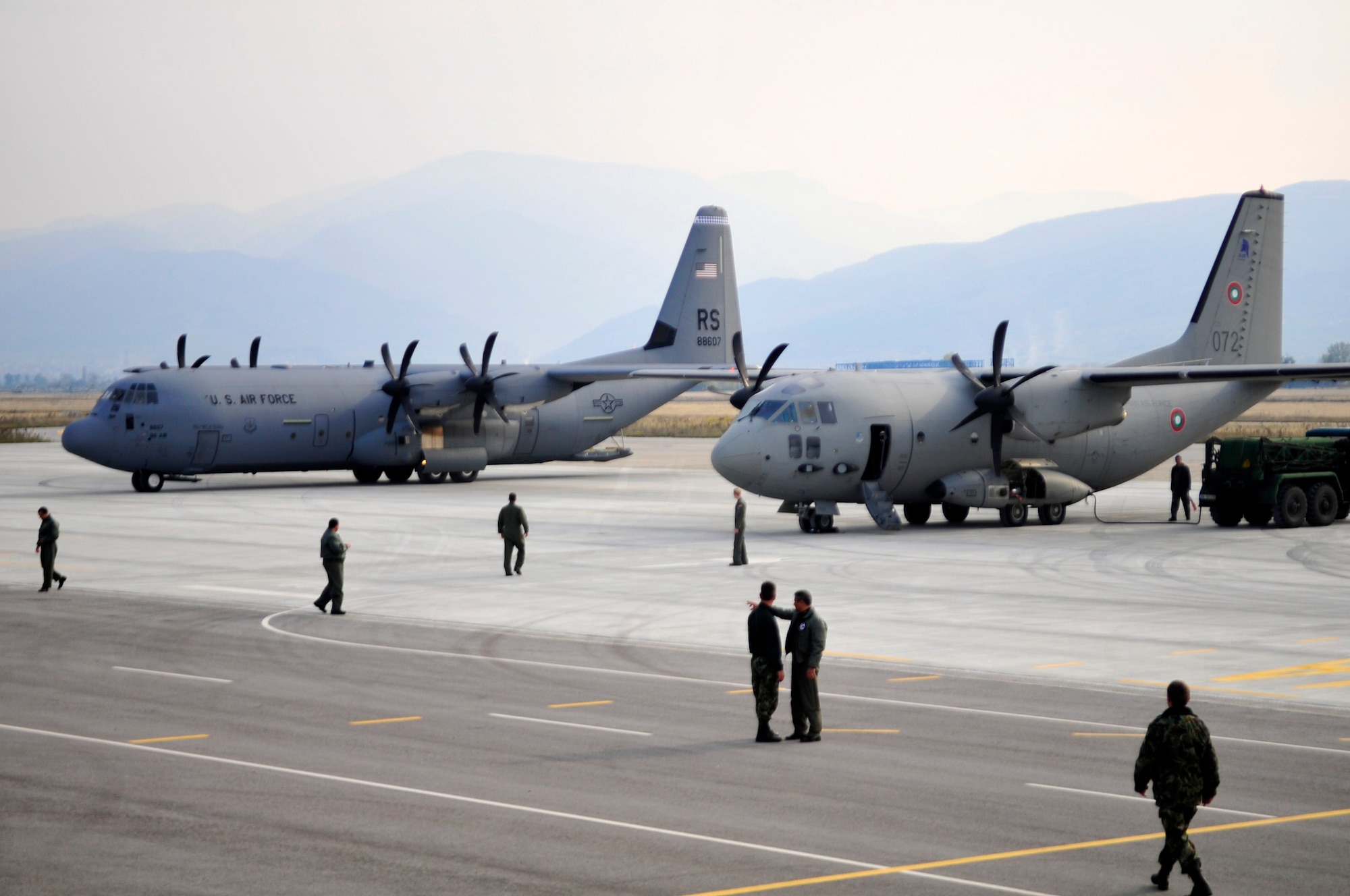 A U.S. Air Force C-130J Super Hercules and a Bulgarian C-27 Spartan sit side by side at the Plovdiv, Bulgaria airport after flying paratrooper missions, during Thracian Fall 2010, Oct. 25. Thracian Fall is a two week on-site training deployment designed to build the partnership between the U.S. and Bulgarian Air Force. (U.S. Air Force photo by Tech. Sgt. Michael Voss)