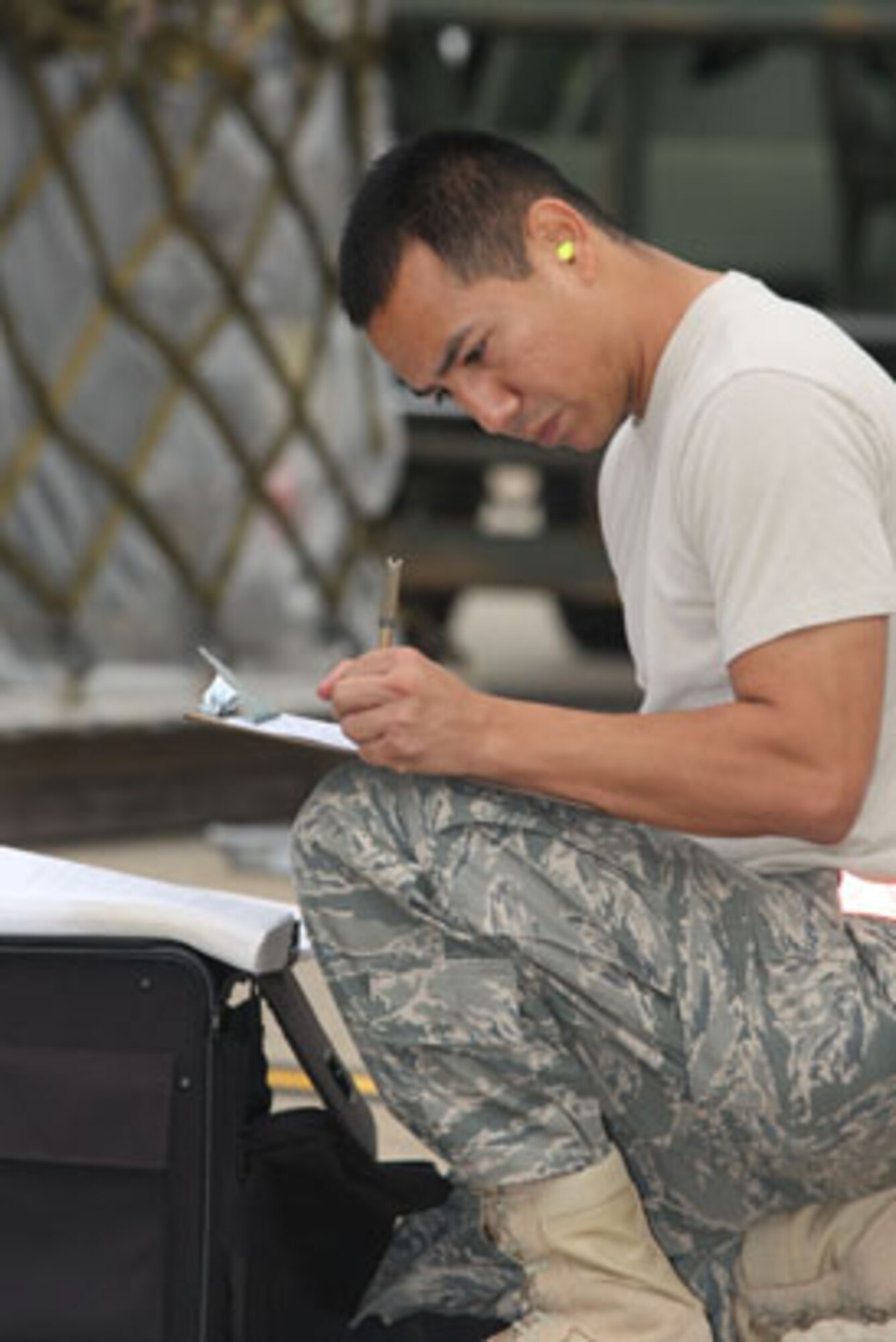 A member of the 48th Aerial Port Squadron completes documentation to ensure cargo is handled correctly and safely during the Joint Inspection event during the 2010 AFRC Port Dawg Challenge Oct 26. (U.S. Air Force photo/Don Peek)