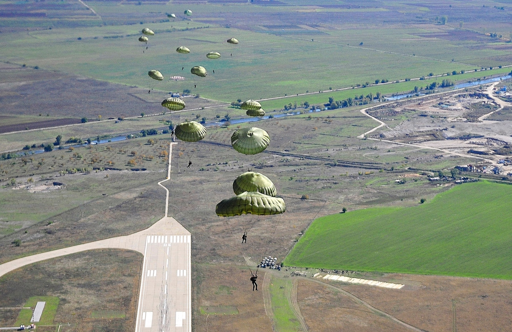U.S. and Bulgarian Air Force paratroopers take to the sky over Plovdiv, Bulgaria, after jumping from a C-130J Super Hercules, Oct 22 during Thracian Fall 2010. The Hercules and U.S. Airmen are deployed from the 86th Airlift Wing and 435th Air Ground Operations Wing at Ramstein Air Base, Germany. (U.S. Air Force photo by Tech. Sgt. Michael Voss)