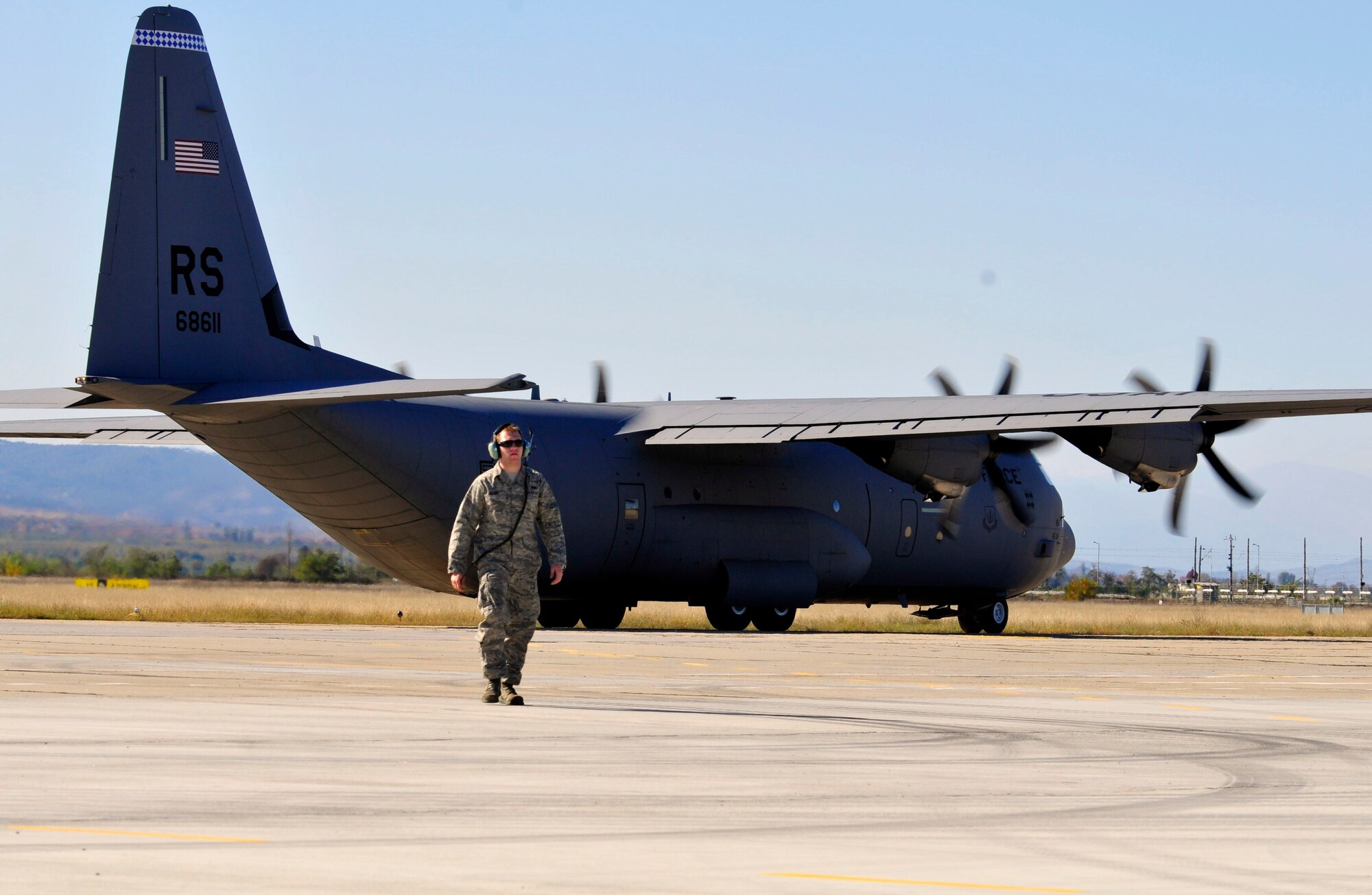 U.S. Air Force Senior Airman Shaun Moody from the 86th Aircraft Maintenance Squadron marshals out a C-130J Super Hercules as it takes off carrying more than 60 Bulgarian Air Force paratroopers who will jump over the skies of Plovdiv, Bulgaria during Thracian Fall 2010, Oct. 22. Thracian Fall is a two week building partnership capacity exercise between U.S. and Bulgarian airmen. (U.S. Air Force photo by Tech. Sgt. Michael Voss)