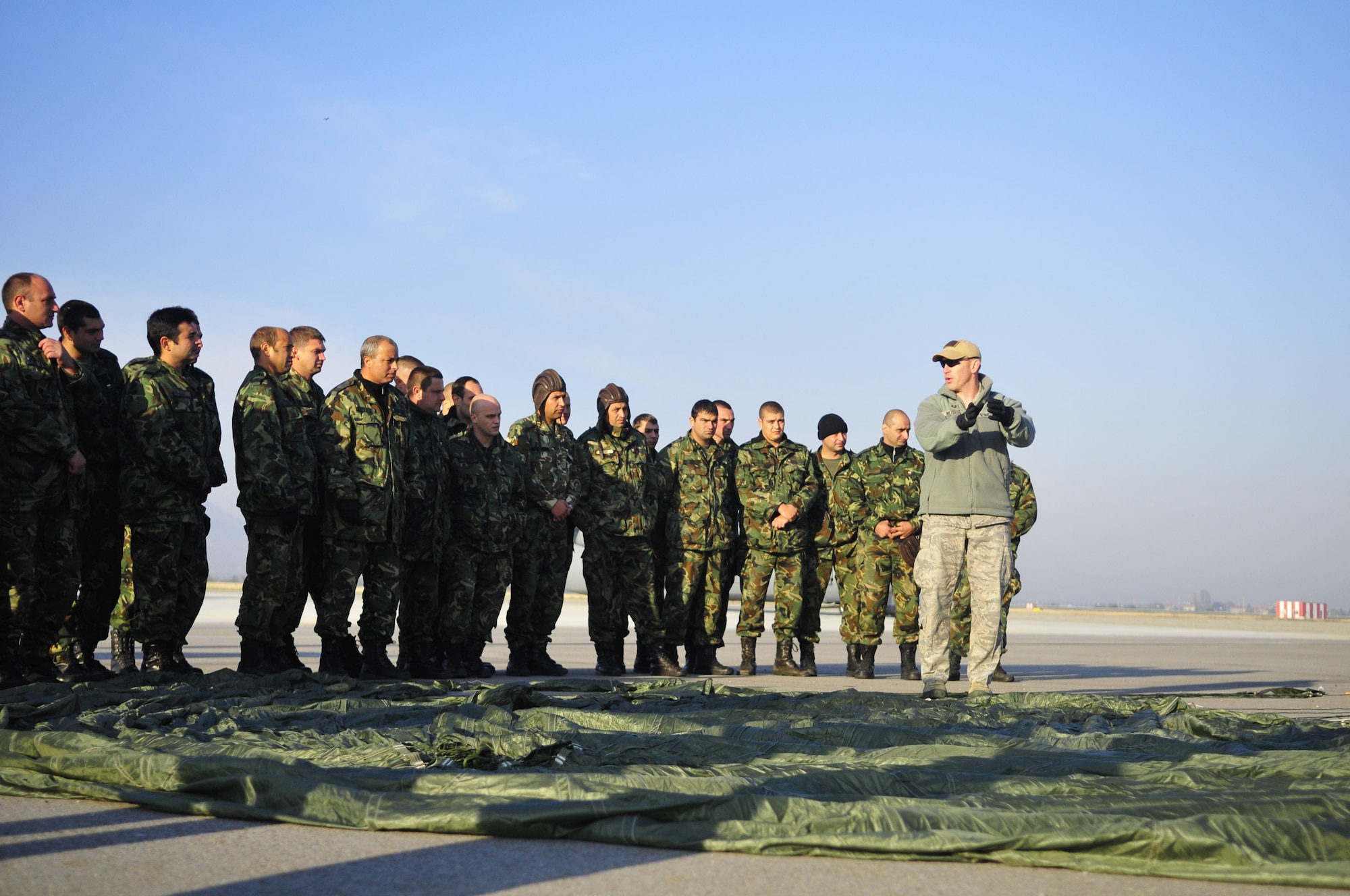 U.S. Air Force Tech. Sgt. Kurtis Musson from the 435th Contingency Response Group goes over some safety procedures with Bulgarian paratroopers prior to jumping from a C-130J Super Hercules in Plovdiv, Bulgarian, Oct. 25. The Airmen are participating in Thracian Fall 2010, a two week on-site training deployment designed to build partnership between the U.S. and Bulgarian Air Force. During Thracian Fall U.S. paratroopers were able to assist 1077 Bulgarian Airmen receive valuable jump training. (U.S. Air Force photo by Tech. Sgt. Michael Voss)