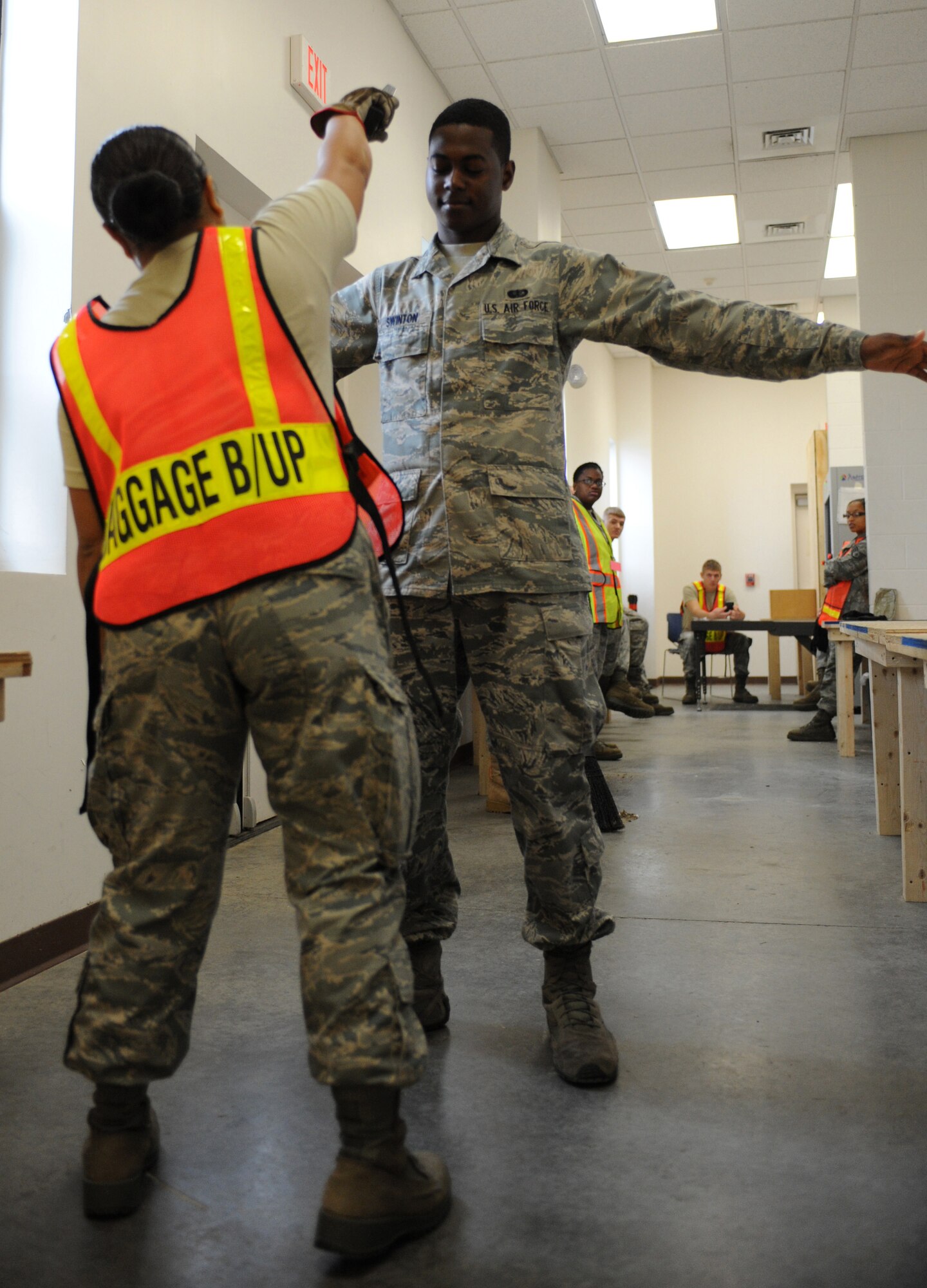 SEYMOUR JOHNSON AIR FORCE BASE, N.C. -- Senior Airman Rhodora Santos uses a body scan/metal detector on Airmen passing through the Personnel Deployment Facility here, Oct. 26 2010. As part of the baggage build-up team, Airman Santos helped scan mobility bags and keep order as hundreds of Airmen processed for simulated deployments during this week's operational readiness inspection. Airman Santos, 4th Communications Squadron knowledge operations manager, is from Vacaville, Calif. (U.S. Air Force photo/Senior Airman Makenzie Lang)(RELEASED)