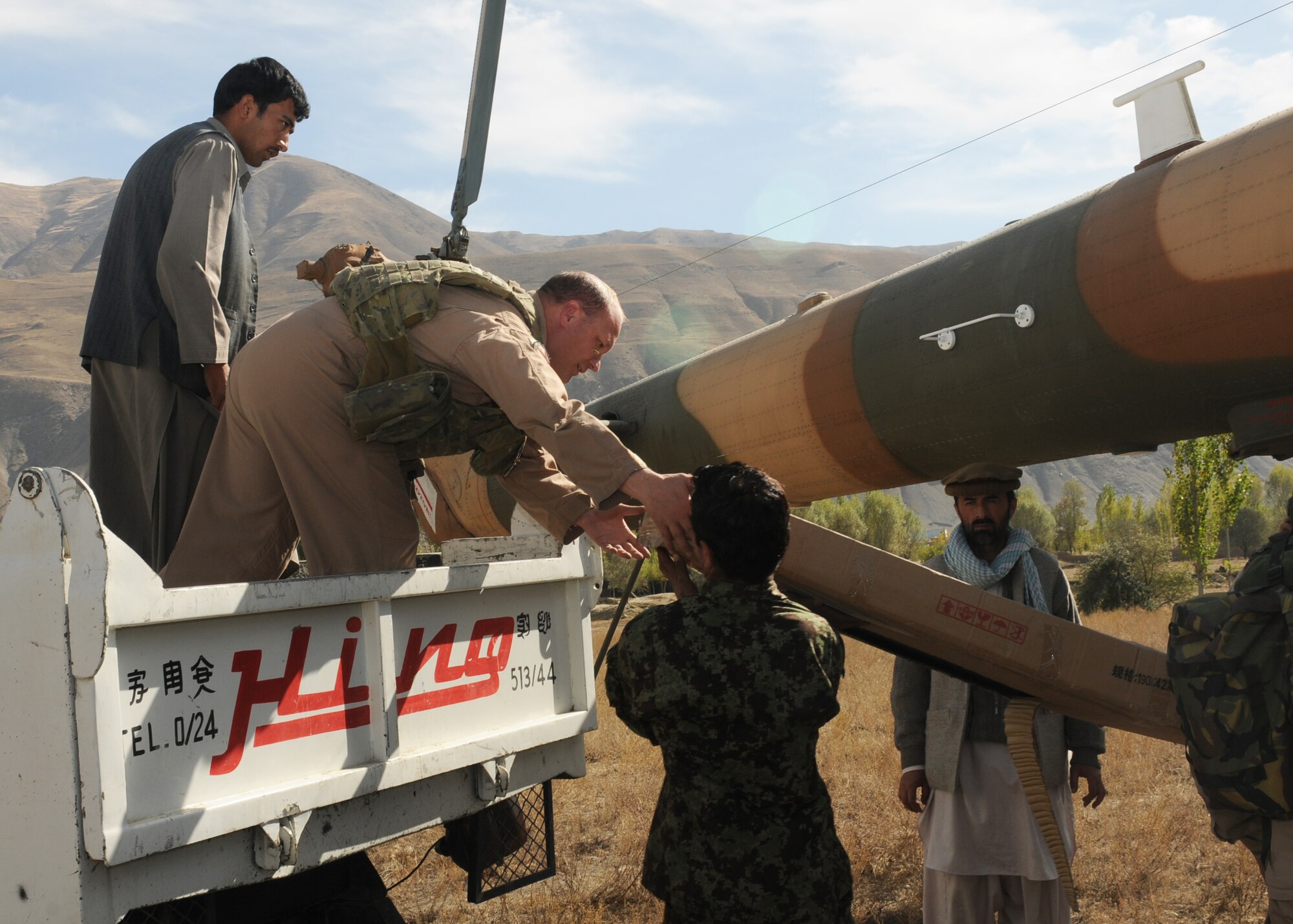 BADAKHSHAN, Afghanistan -- Afghan Air Force and Coalition forces deliver aid to the province of Badakhsan Oct. 26 as part of continued humanitarian assistance to the region. More than 2,000 kilograms of toys, clothes, furniture and school supplies were distributed during the mission. (US Air Force photo by MC2 Vladimir Potapenko/Released). 