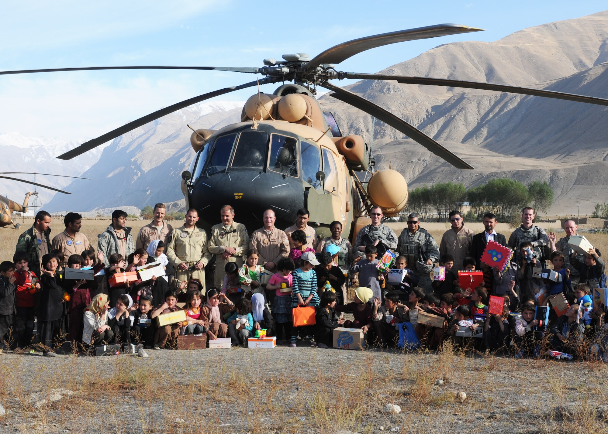 BADAKHSHAN, Afghanistan -- Afghan Air Force and Coalition forces deliver aid to the province of Badakhsan Oct. 26 as part of continued humanitarian assistance to the region. More than 2,000 kilograms of toys, clothes, furniture and school supplies were distributed during the mission. (US Air Force photo by MC2 Vladimir Potapenko/Released). 