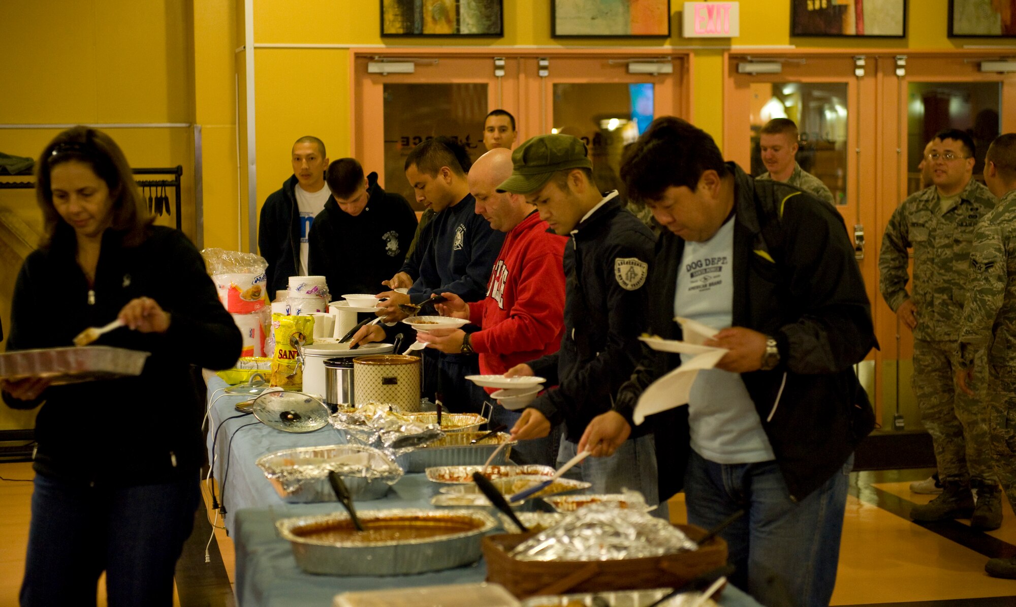 Unaccompanied service members line up for a free home-cooked meal at the Grid, Oct. 27, 2010, at Misawa Air Base, Japan. The 35th Fighter Wing Staff Agencies hosted the dinner with the Armed Forces Network for more than 130 hungry Misawa members. (U.S. Air Force photo by Staff Sgt. Samuel Morse/Released)