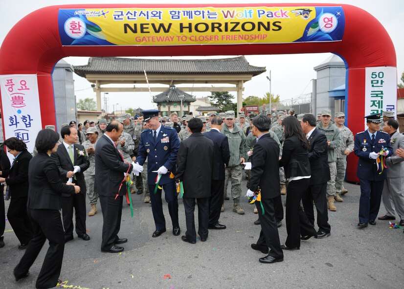 KUNSAN AIR BASE, Republic of Korea -- Col. John Dolan, 8th Fighter Wing commander, shakes hands with Gunsan City officials after the New Horizons ribbon cutting ceremony here Oct. 27, 2010. The event marked the lifting of the fifty-year-old three-mile restriction surrounding Kunsan Air Base. (U.S. Air Force photo/Senior Airman Ciara Wymbs) 